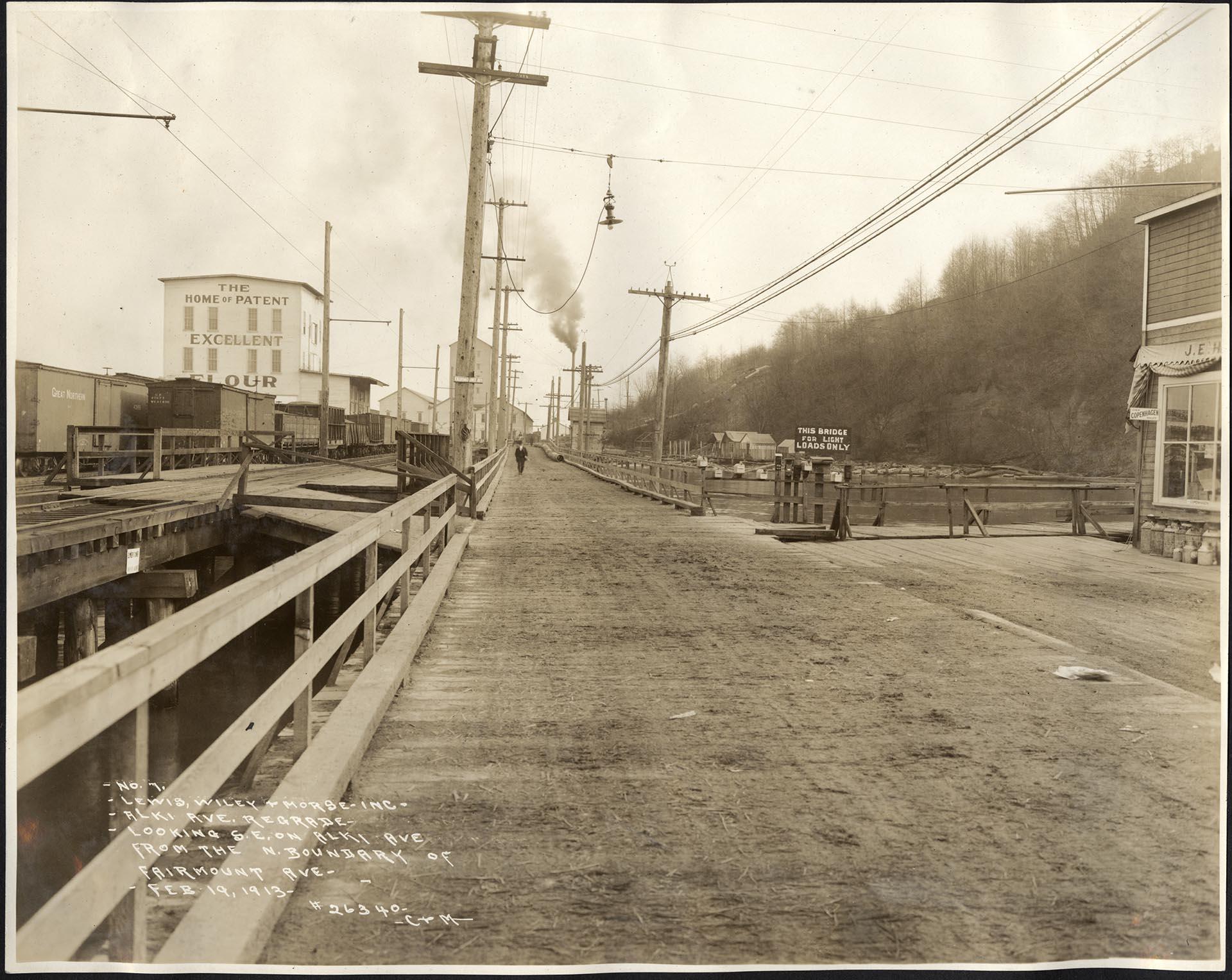 Image of Alki Avenue with railroad tracks and flour mill, Seattle, February 19, 1913