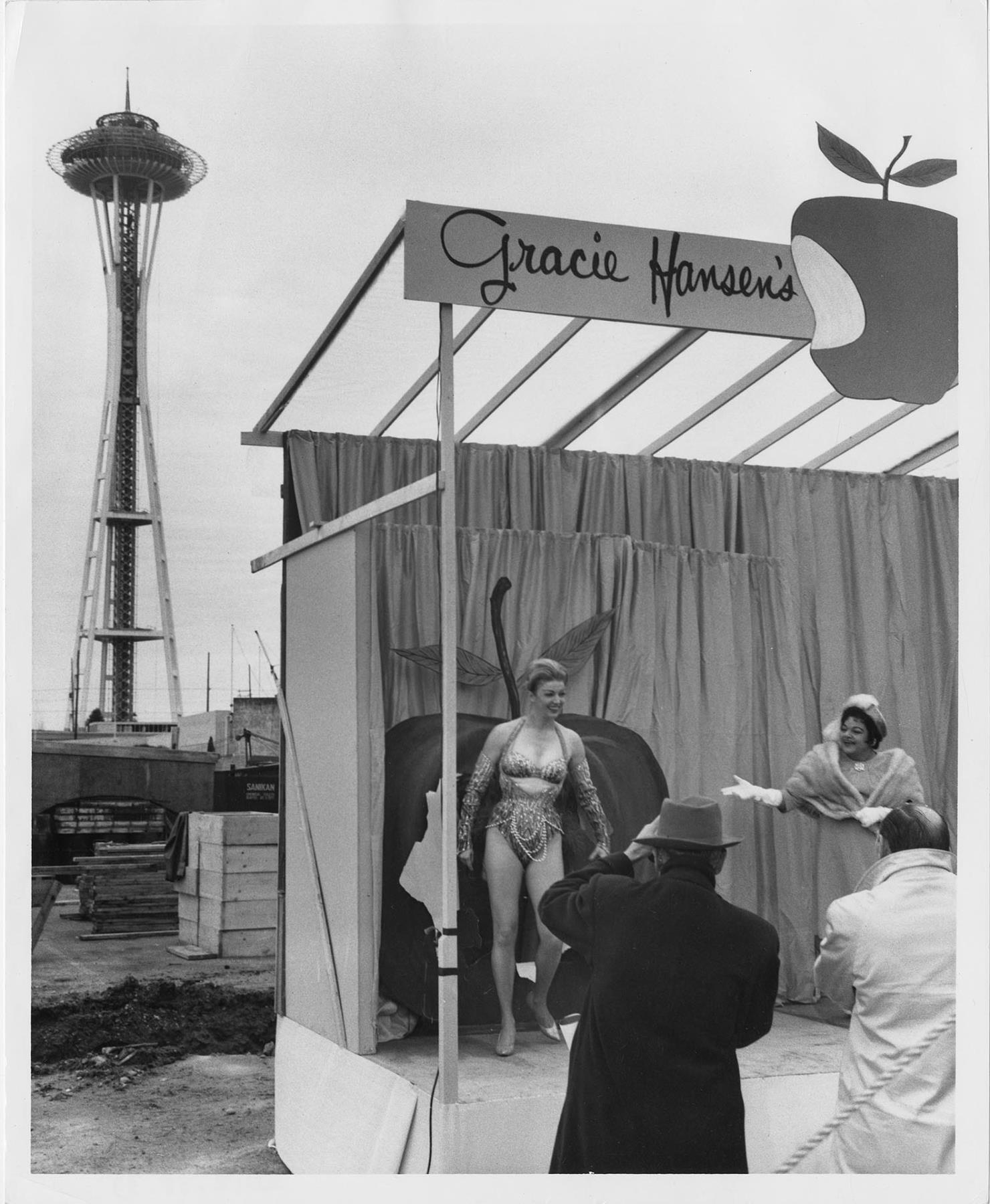 Image of Donna Rydberg in costume on makeshift stage with Gracie Hansen, 1961