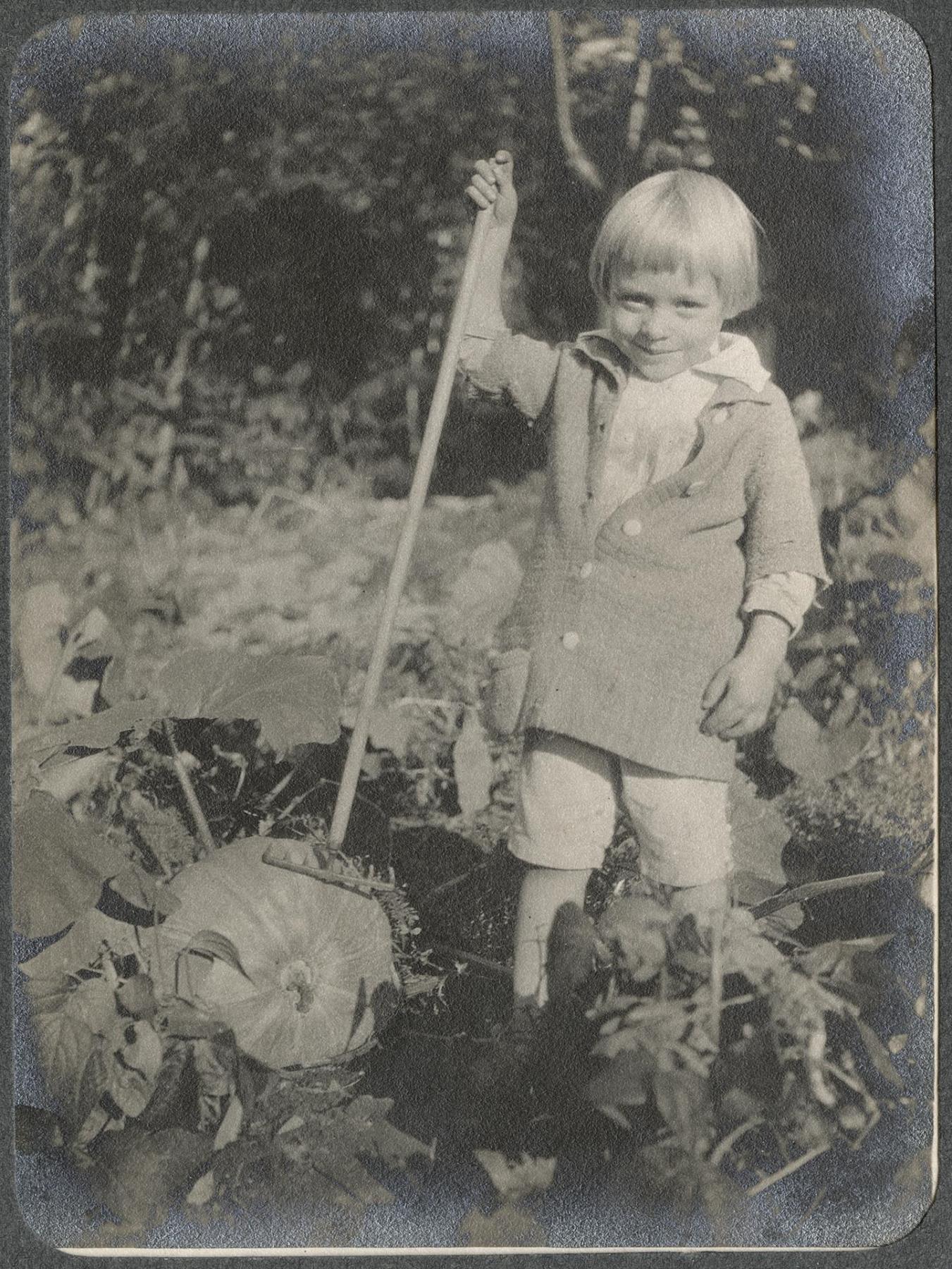 Image of Alfred Renfro, Jr. playing in garden at Beaux Arts Village, circa 1910