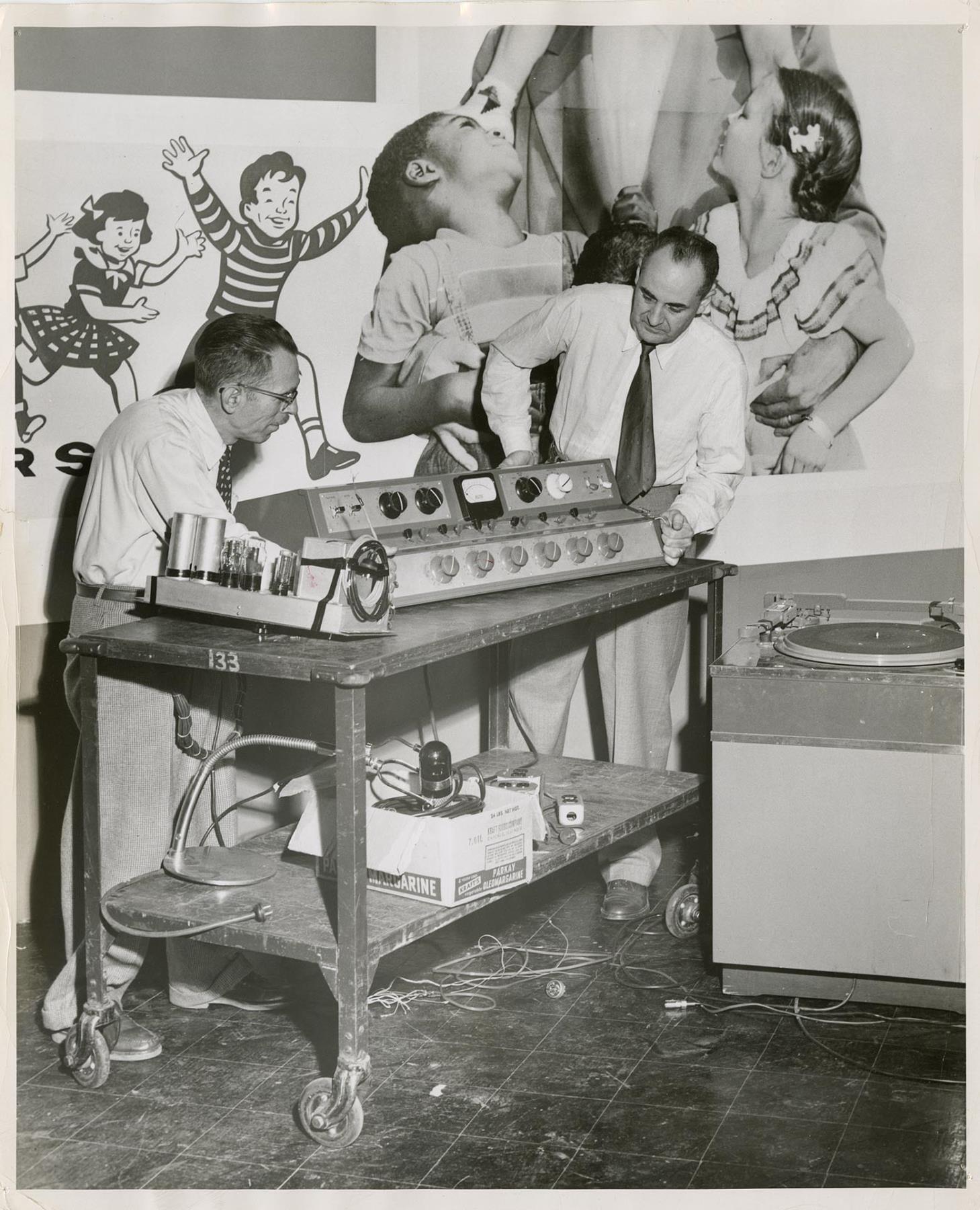 Image of KIRO studio engineer James Upthegrove and engineer John Dubuque with radio equipment, Seattle, circa 1955