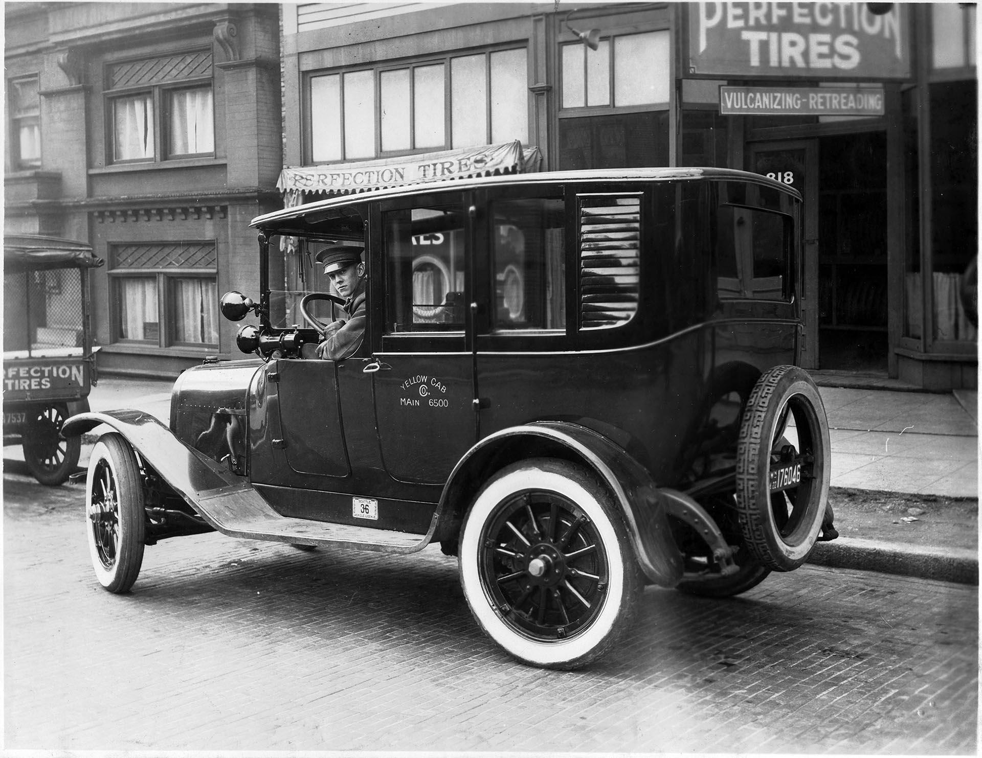 Image of Yellow cab in front of Perfection Tires, Seattle, circa 1920