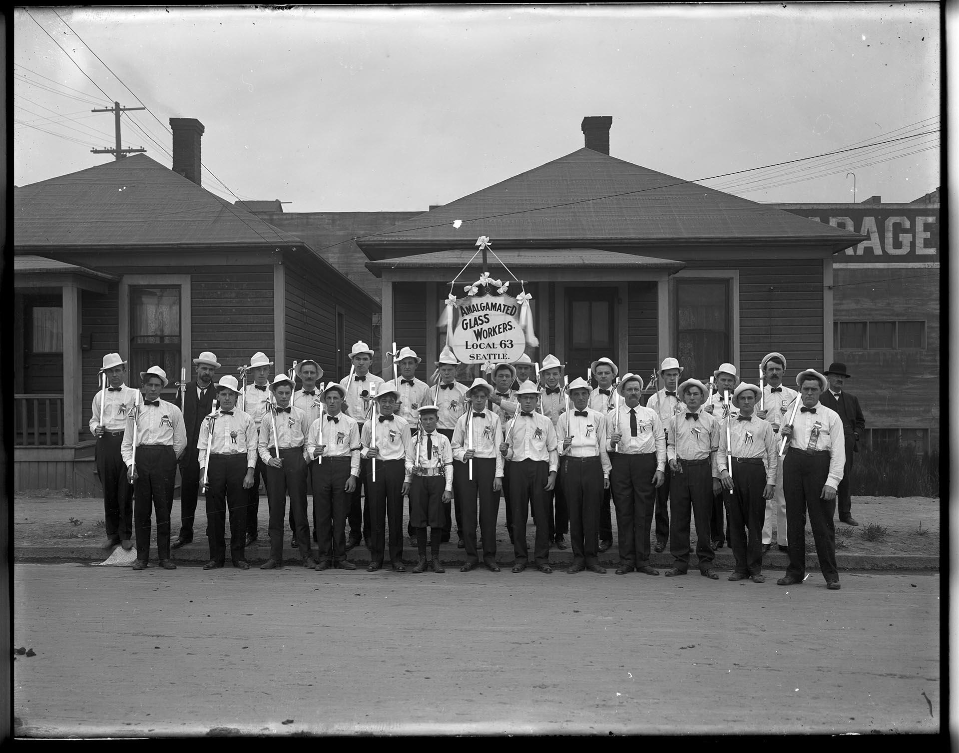 Image of Members of the Amalgamated Glass Workers Local Union 63 posing with banner, Seattle, circa 1900