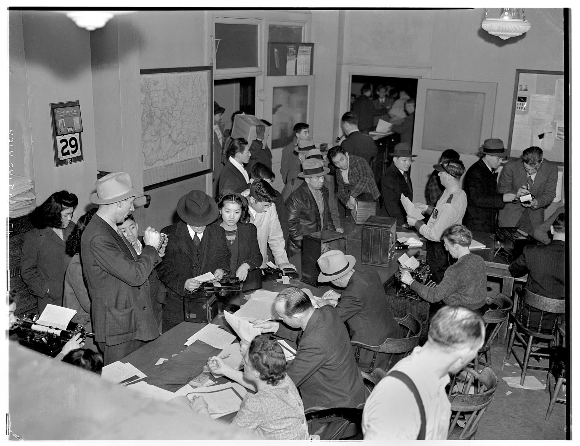 Image of Japanese Americans surrendering equipment to police, Seattle, December 29, 1941
