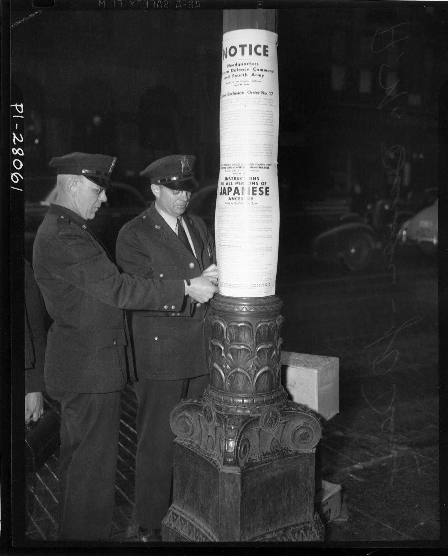 Image of Two policemen posting Civilian Exclusion Order No. 17, Seattle, June 16, 1942
