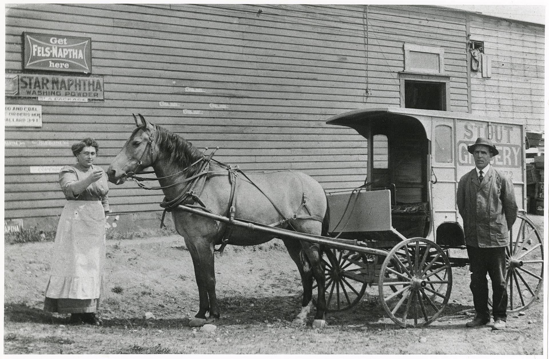 Image of James and Ethel Stout with their delivery wagon in front of Stout Grocery, Seattle, circa 1913