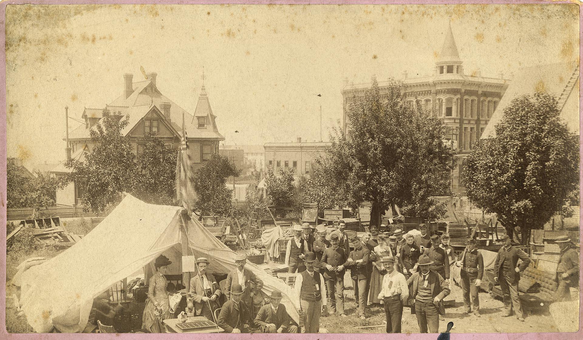 Image of Seattleites posing with goods salvaged from the fire, June 1889