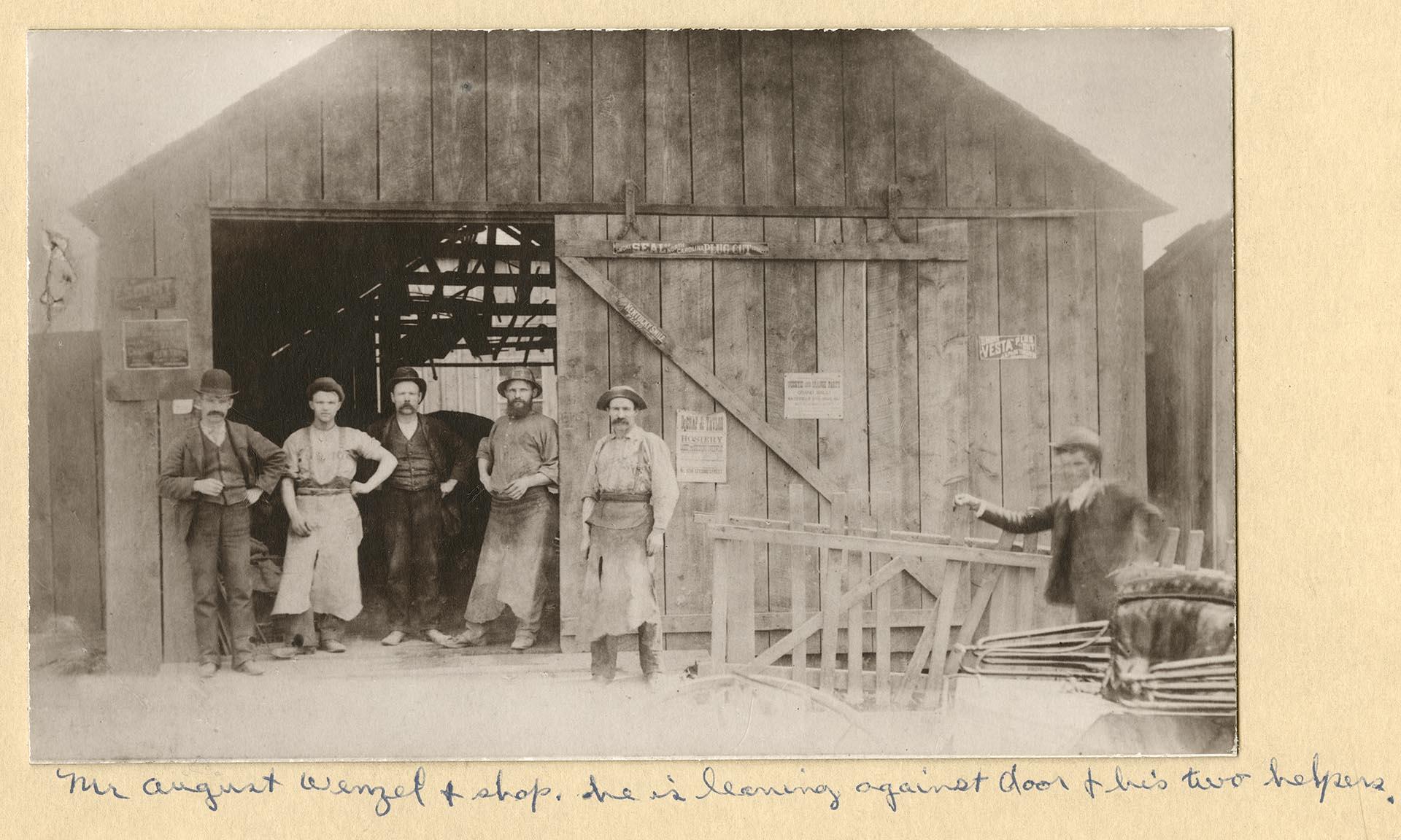Image of August Wenzel in front of his blacksmith shop at 7th and Pike, Seattle, 1889