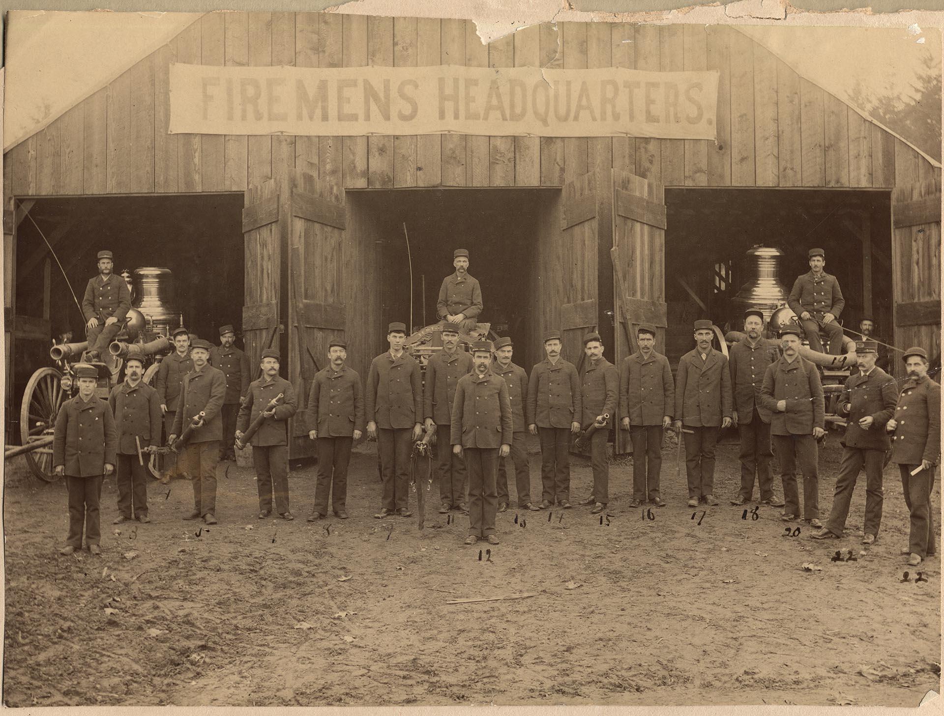 Image of Firemen posing outside Seattle Fire Department, November 1889