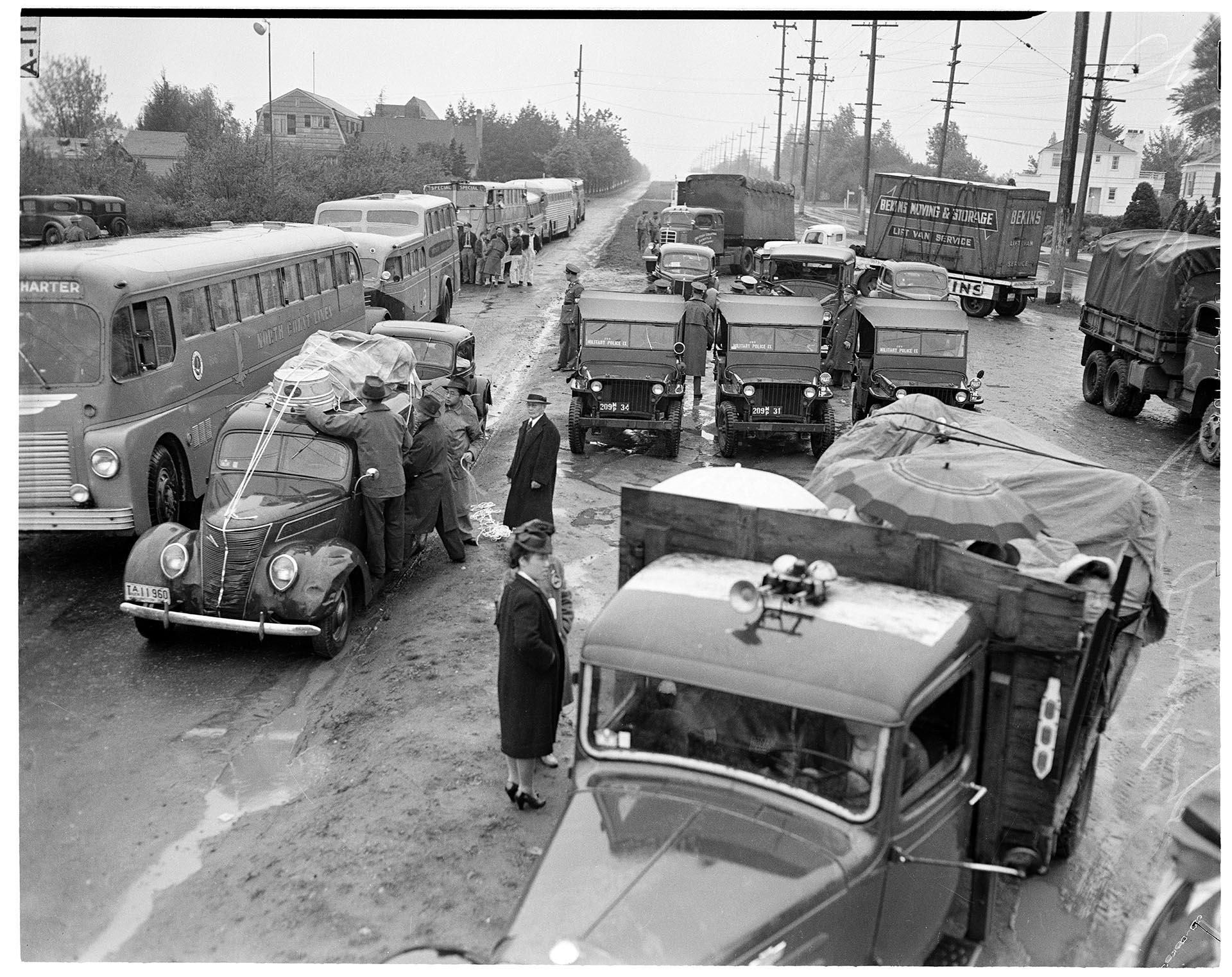 Image of U. S. soldiers and Japanese Americans preparing for forced removal, Bainbridge Island, March 30, 1942