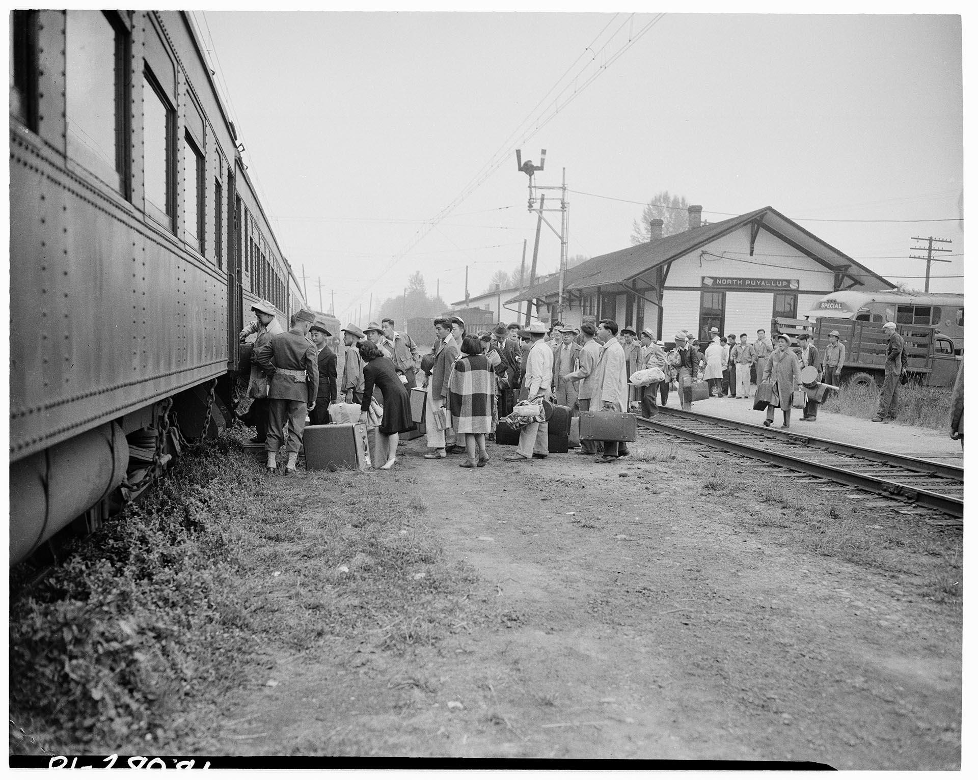 Image of Japanese Americans boarding train for Minidoka War Relocation Center, Puyallup, 1942