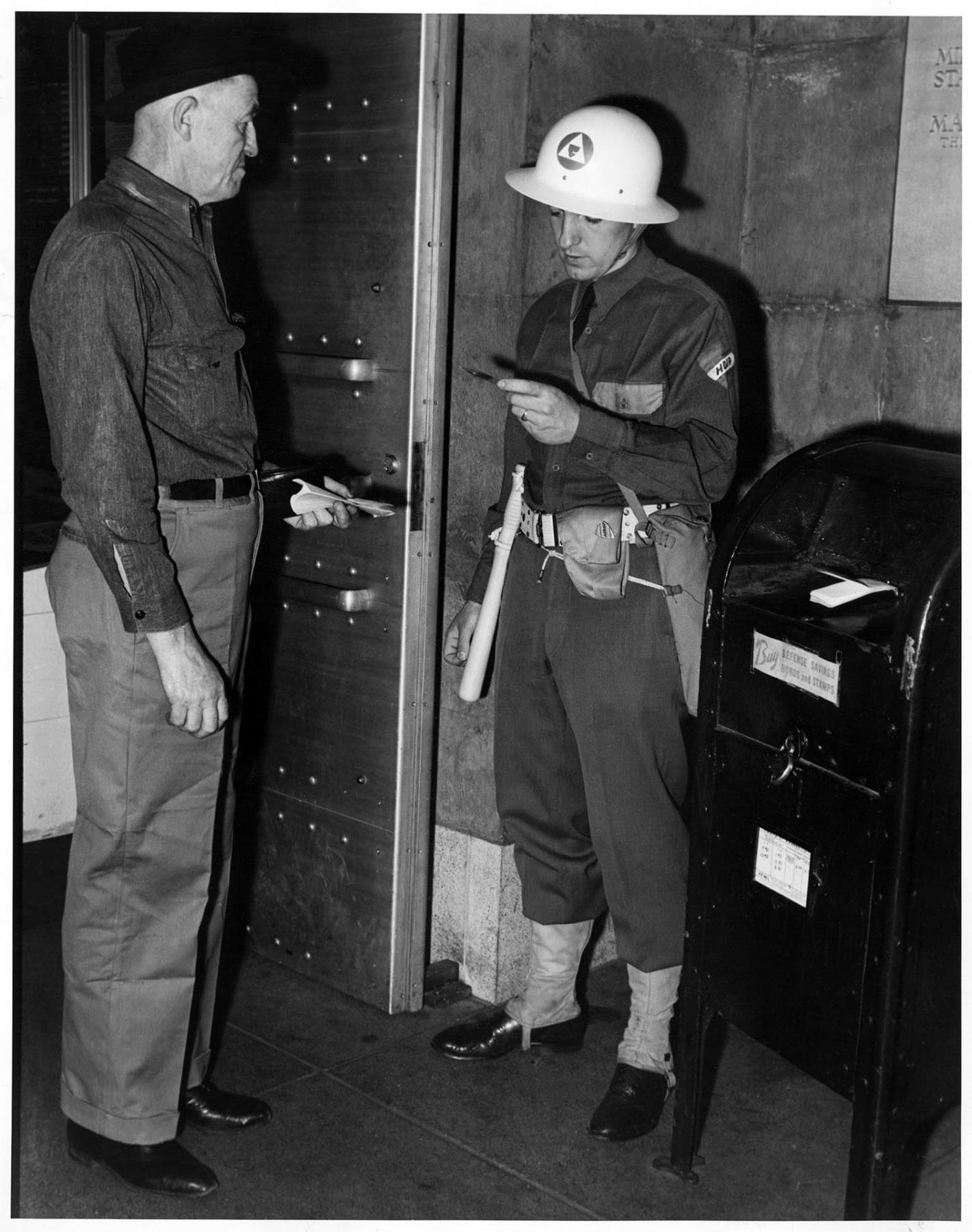 Image of HDIR member checking documentation, Seattle, circa 1941