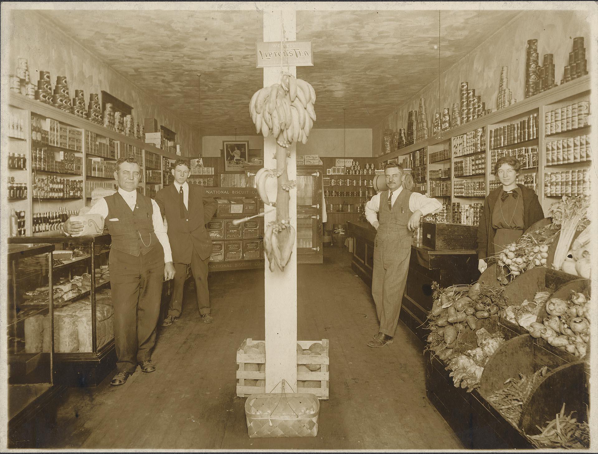 Image of Thomas and Warren French posing inside their grocery store, Seattle, circa 1910