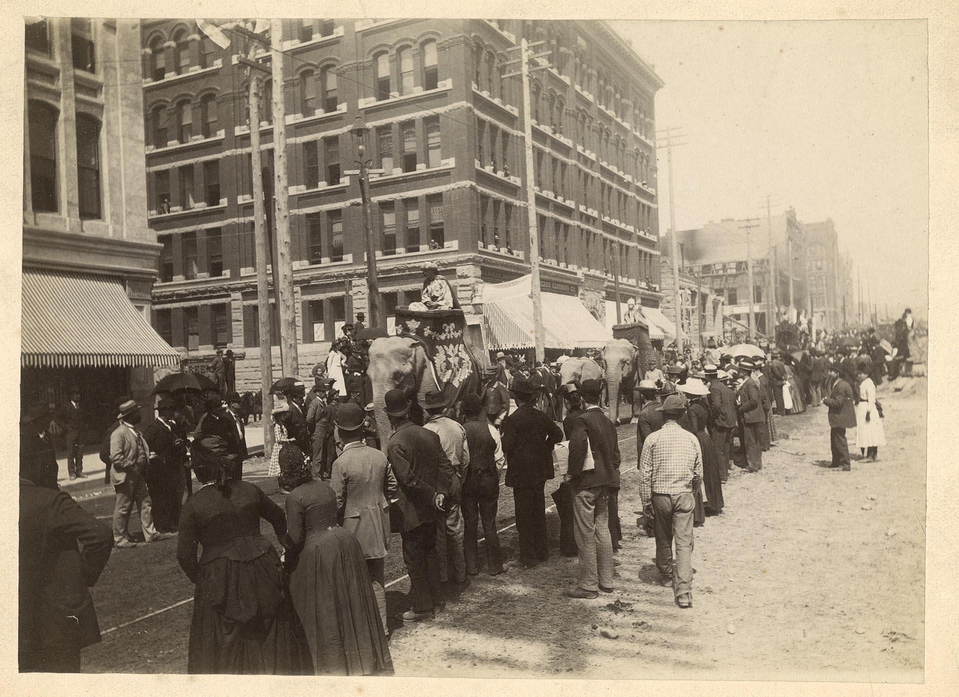 Image of Spectators watching a circus parade on Second Avenue, Seattle, circa 1900