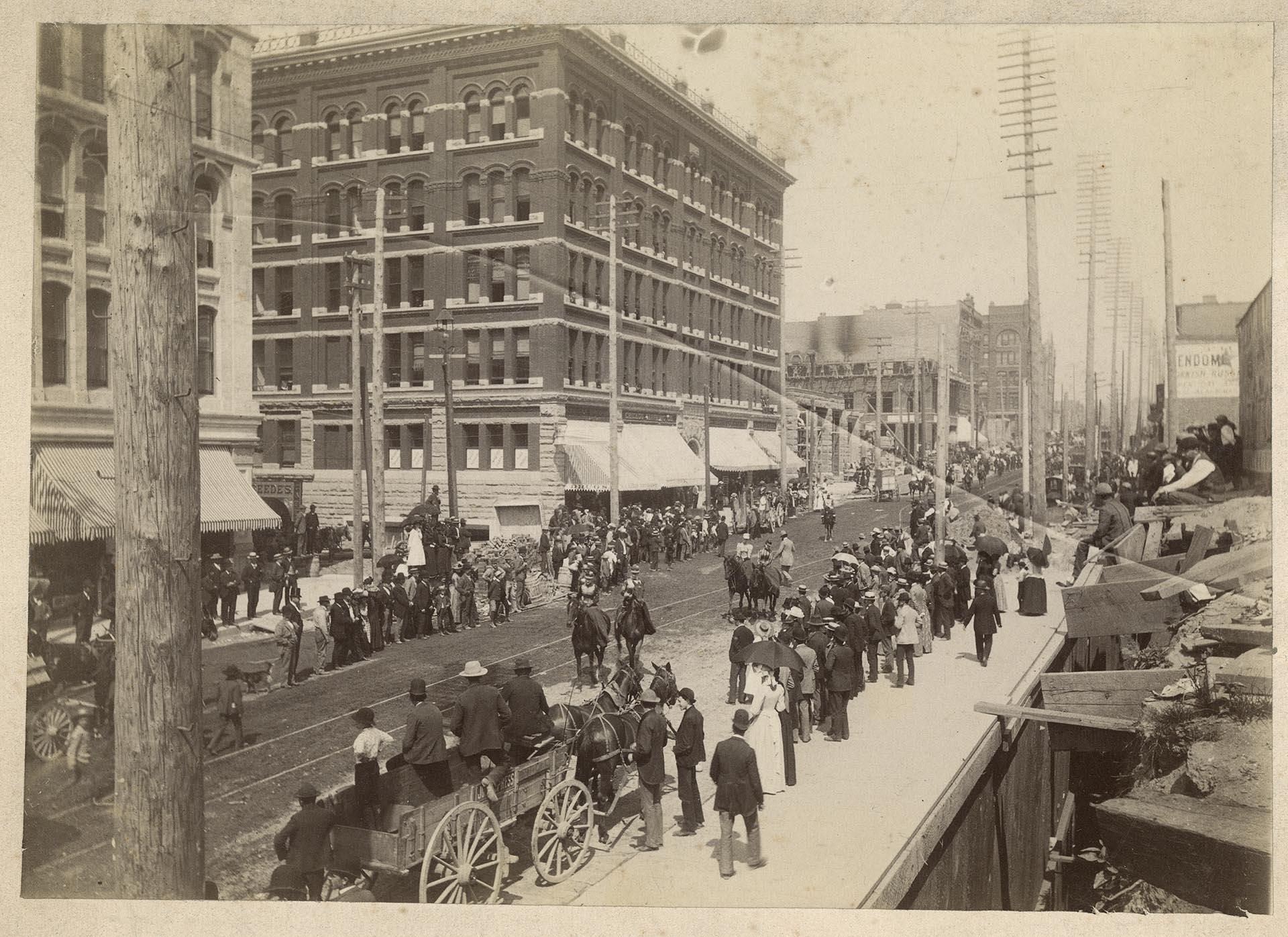 Image of Crowd watching a circus parade on Second Avenue, Seattle, circa 1900