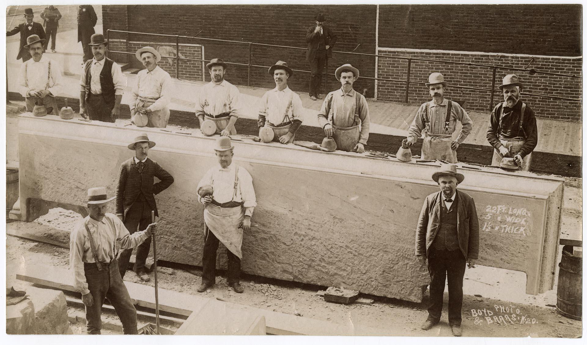 Image of Workmen posing with stone slab, Seattle, circa 1890