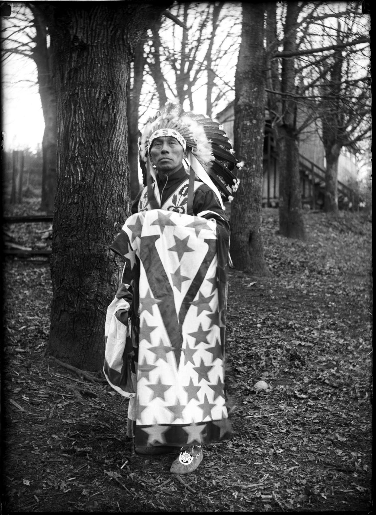 Image of William Shelton posing in traditional garments, circa 1925