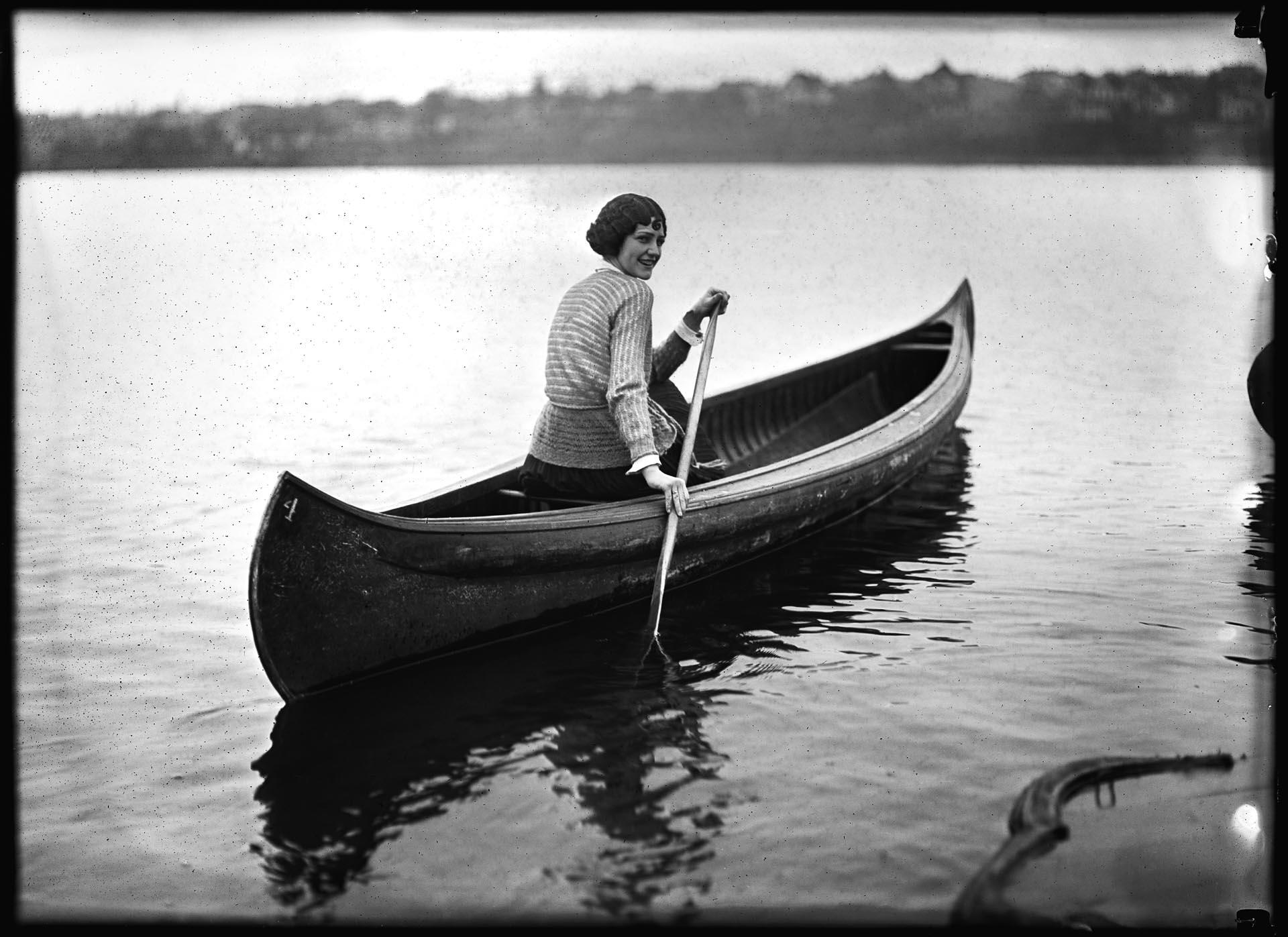 Image of Woman paddling canoe on Green Lake, Seattle, 1923