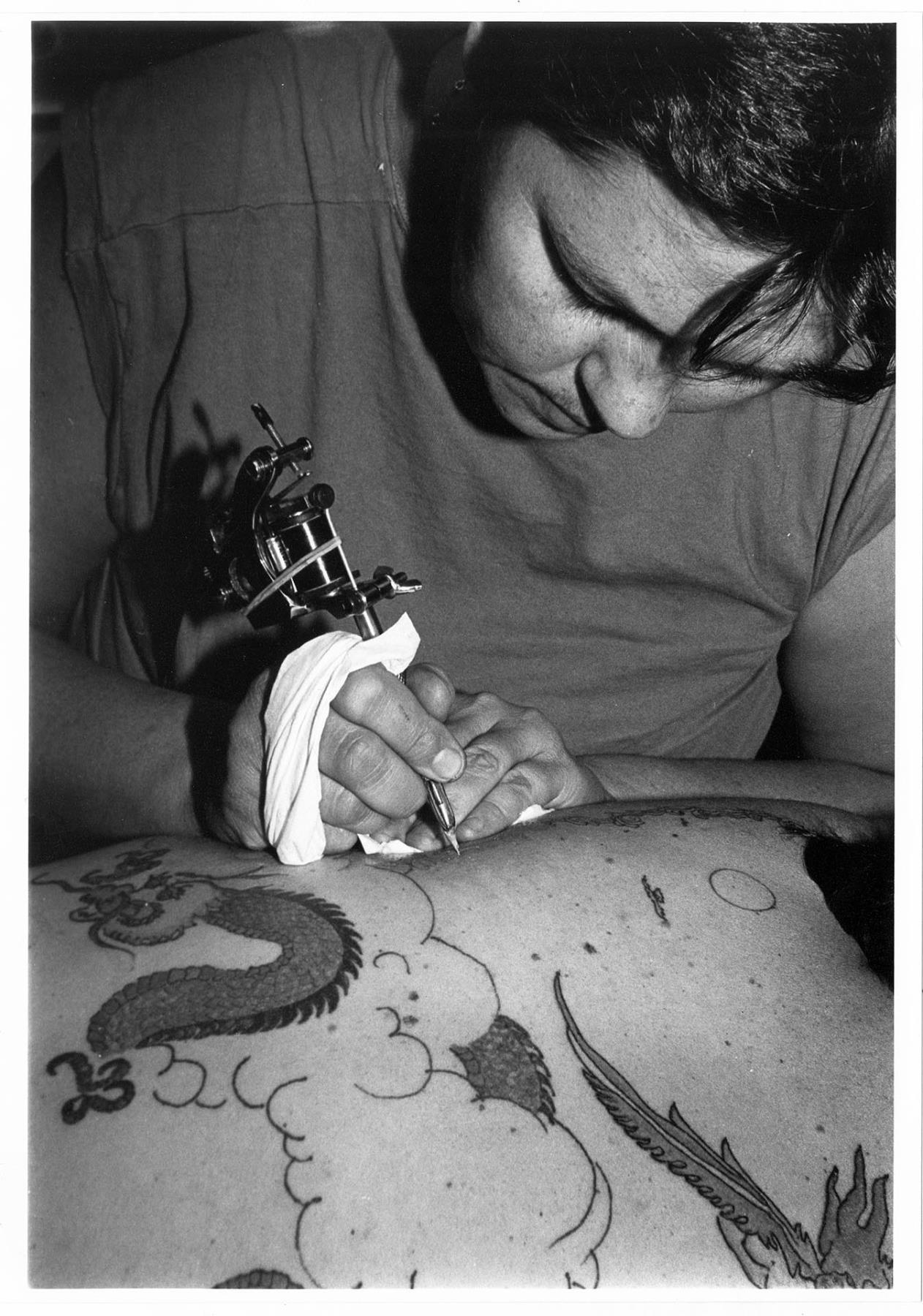 Image of Artist working on tattoo, Seattle, September 23, 1983