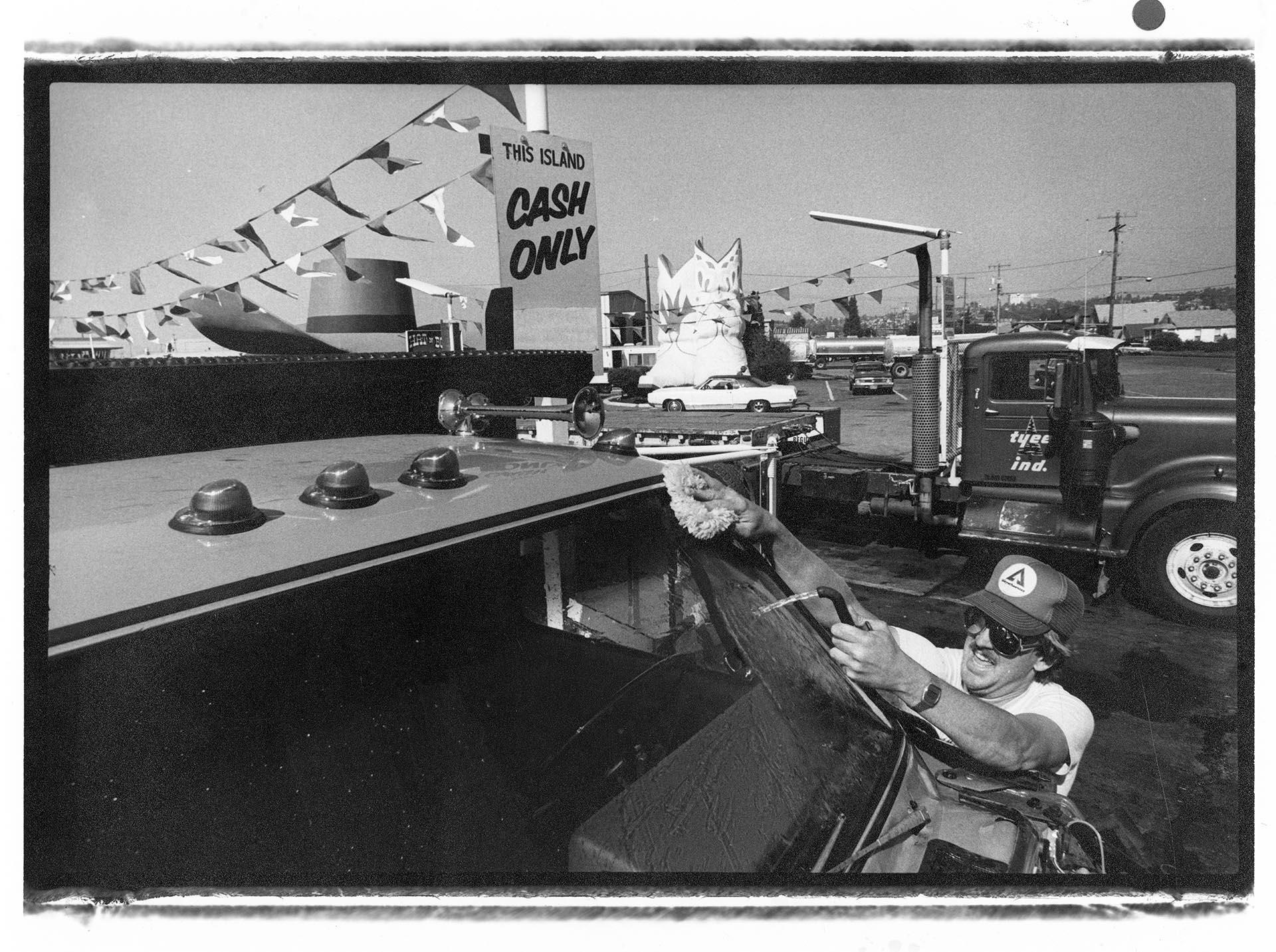 Image of Ted De Coster cleaning windshield, Seattle, September 23, 1983
