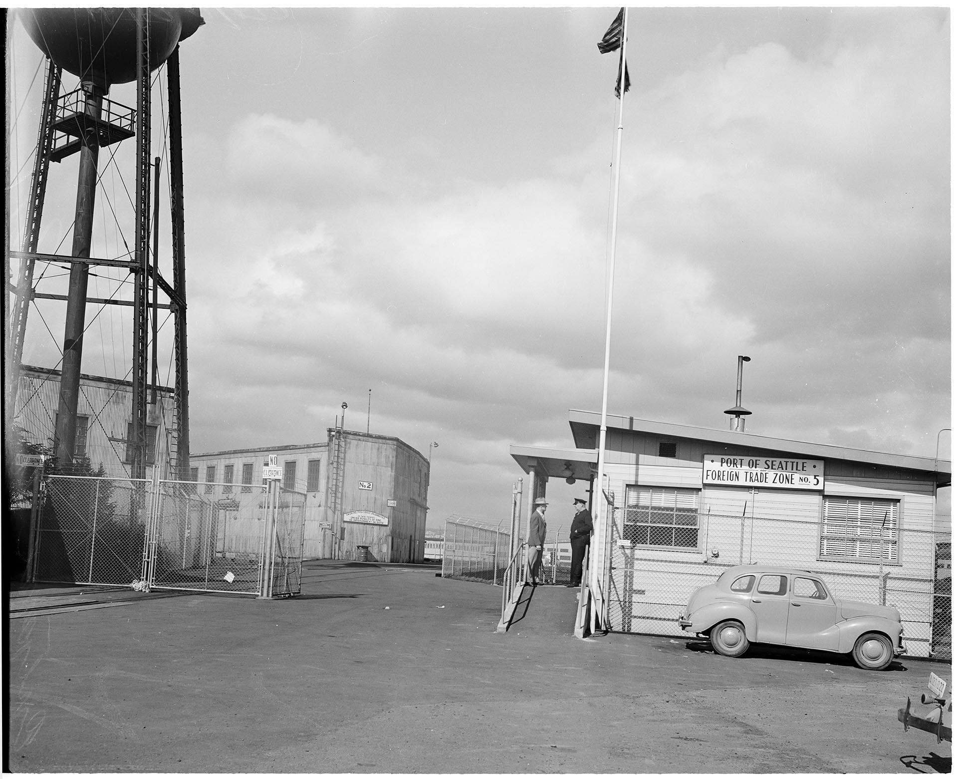 Image of Customs officials standing outside Foreign Trade Zone, Seattle, May 1950