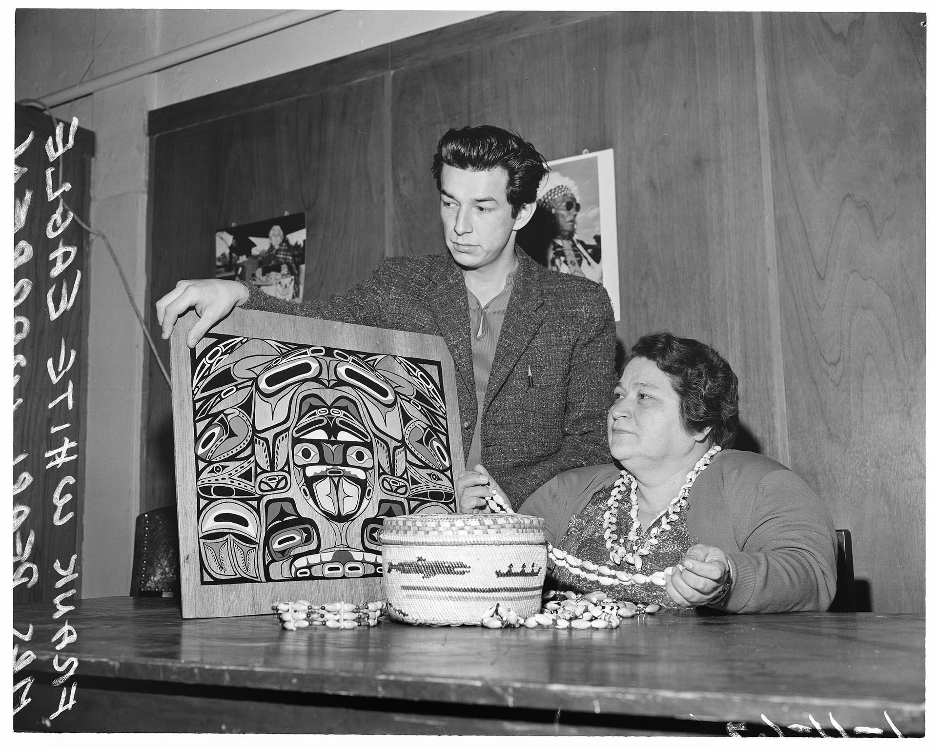Image of Frank White Eagle and Pearl Warren examining Native American art, Seattle, January 1962