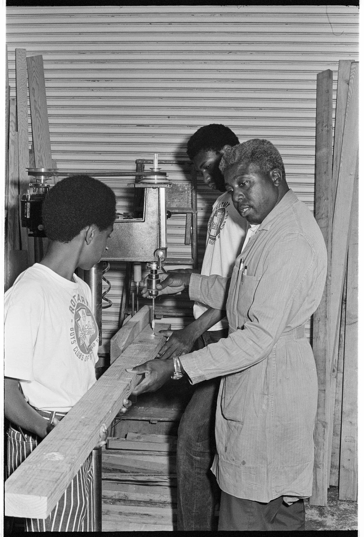 Image of Boys Club members and instructor building shelving, Seattle, August 11, 1970