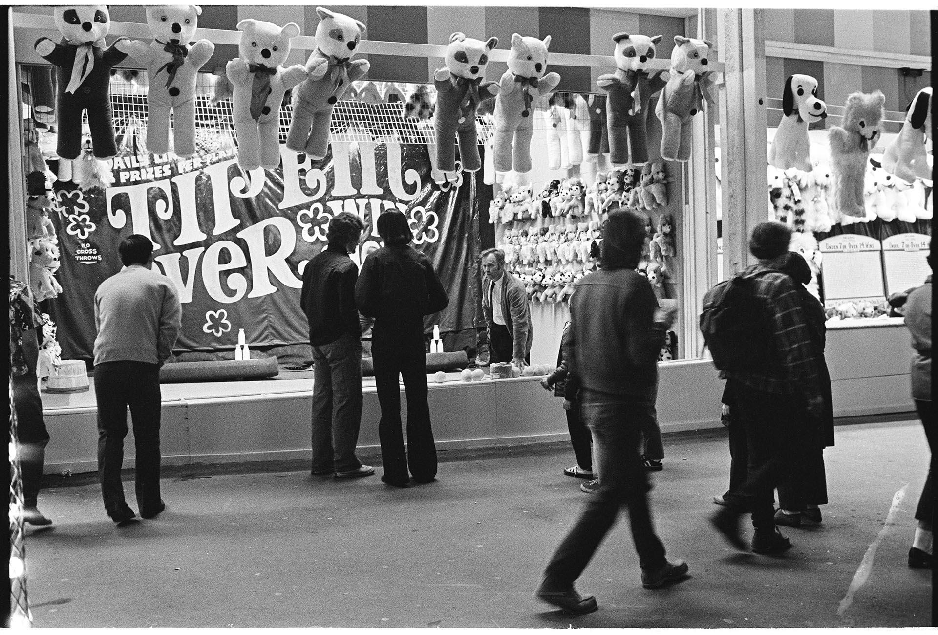 Image of Game operator talking with visitors at Fun Forest, Seattle Center, March 1971