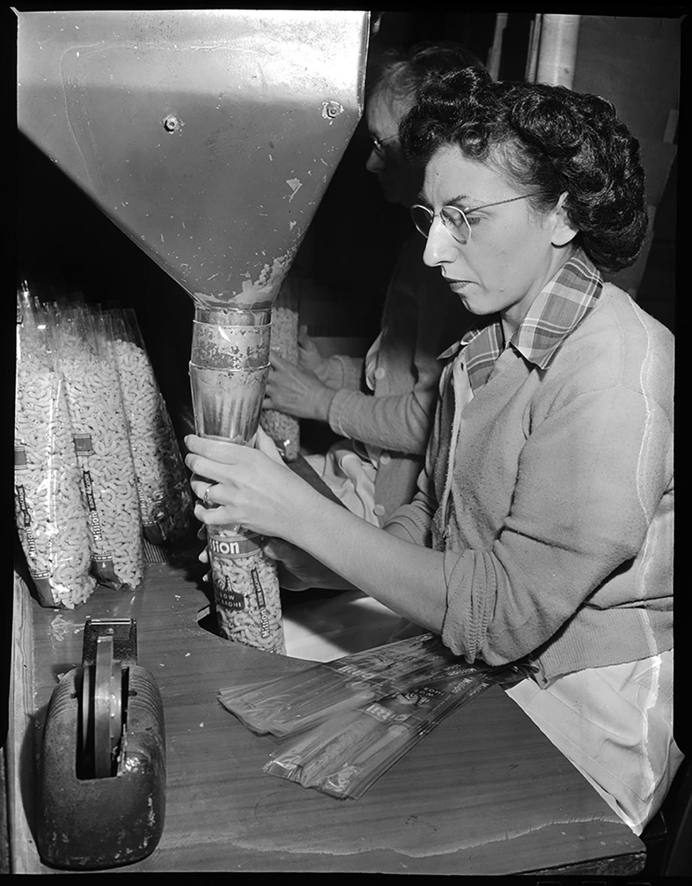 Image of Woman packaging pasta at Mission Macaroni Co., Seattle, January 1952