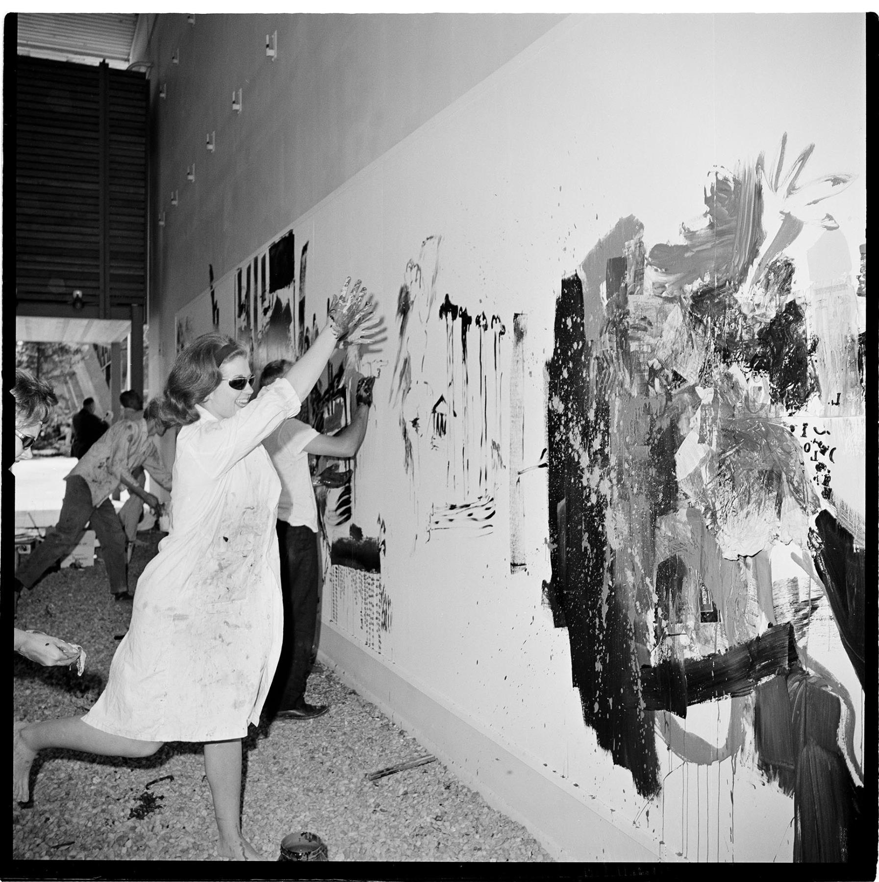 Image of Merrily Dam painting mural at Seattle Center, June 1, 1963