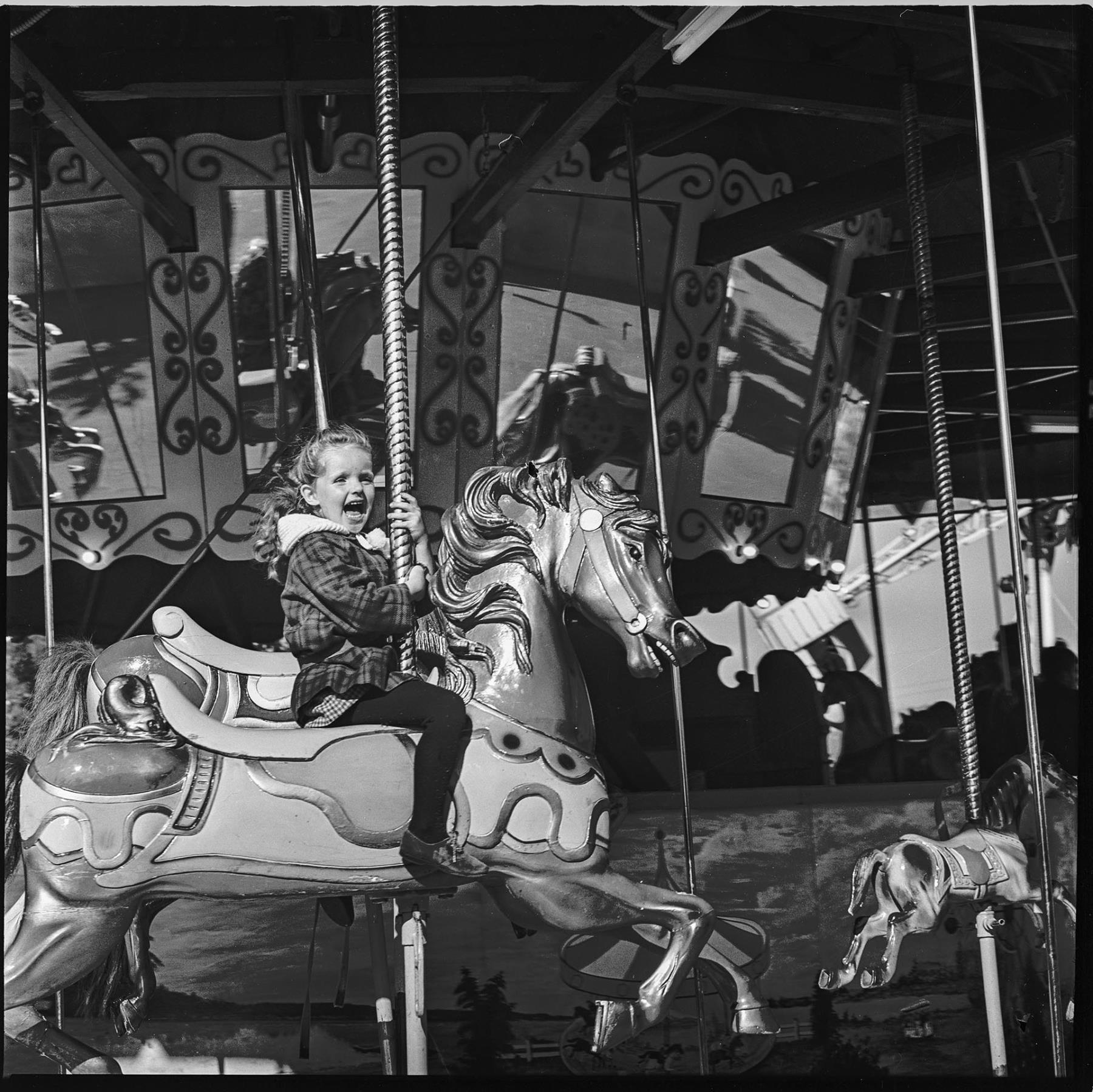 Image of Girl riding carousel at Fun Forest, Seattle Center, September 1965