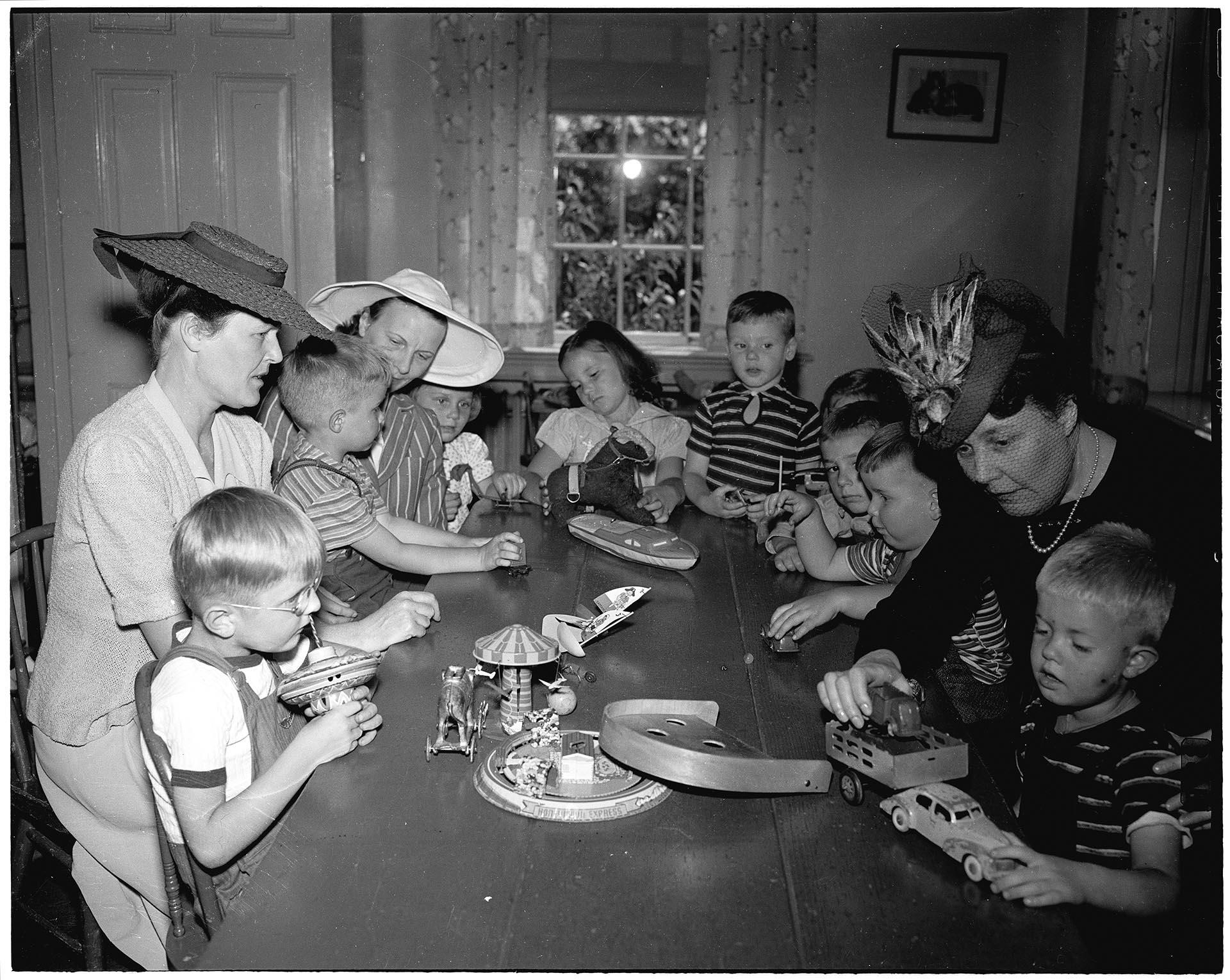 Image of Women and children sitting at table at Seattle Children's Home, December 24, 1942