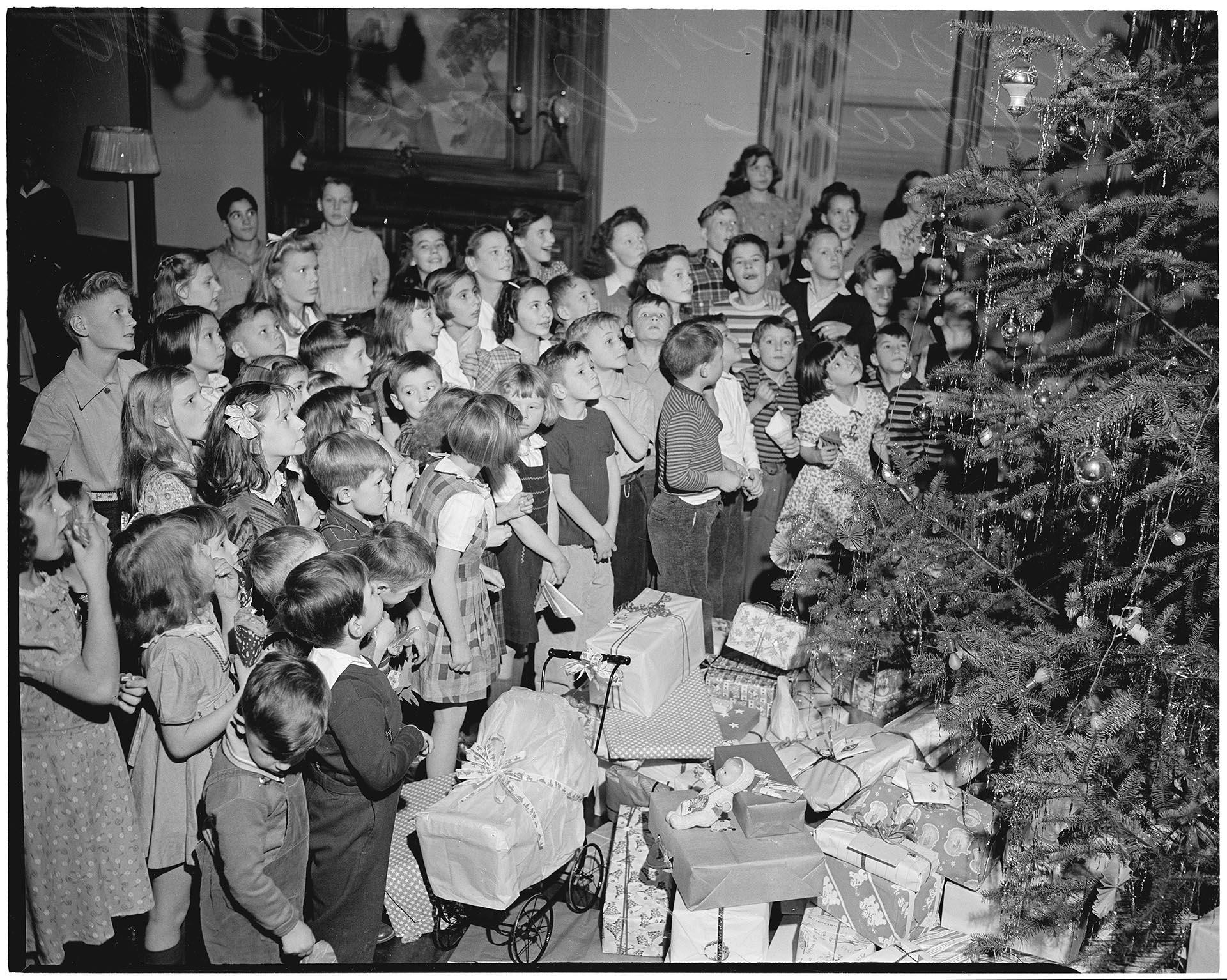 Image of Children looking at Christmas tree at Seattle Children's Home, December 1942