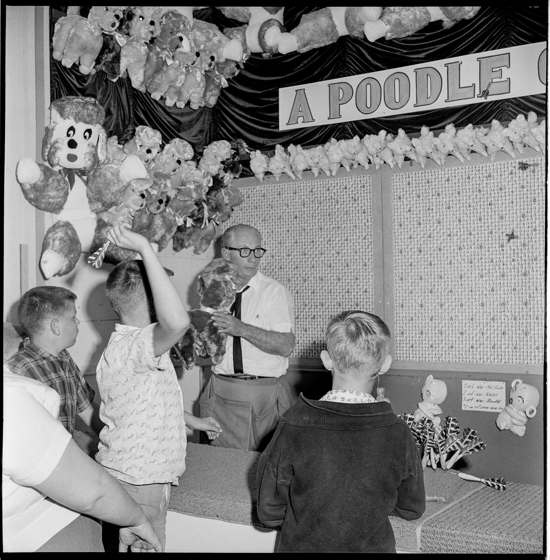 Image of Boy playing carnival game at Fun Forest, Seattle Center, June 1963