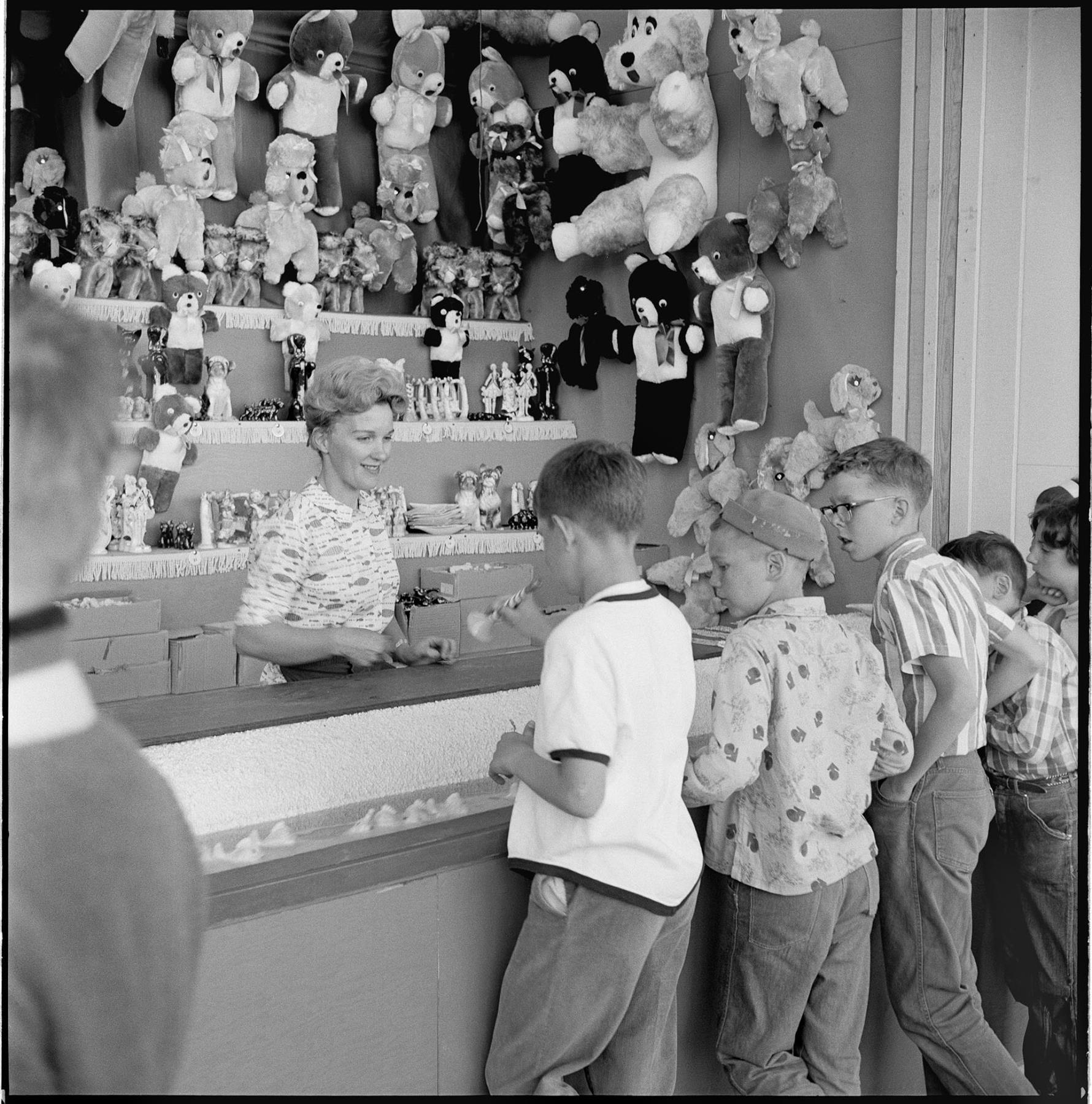 Image of Boys playing carnival game at Fun Forest, Seattle Center, June 1963