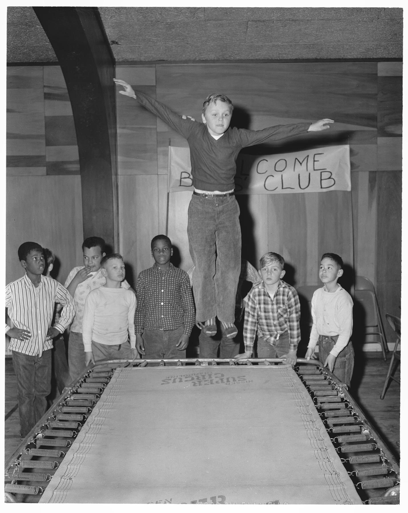 Image of Boy jumping on trampoline at Holly Park Boys Club, Seattle, March 13, 1960