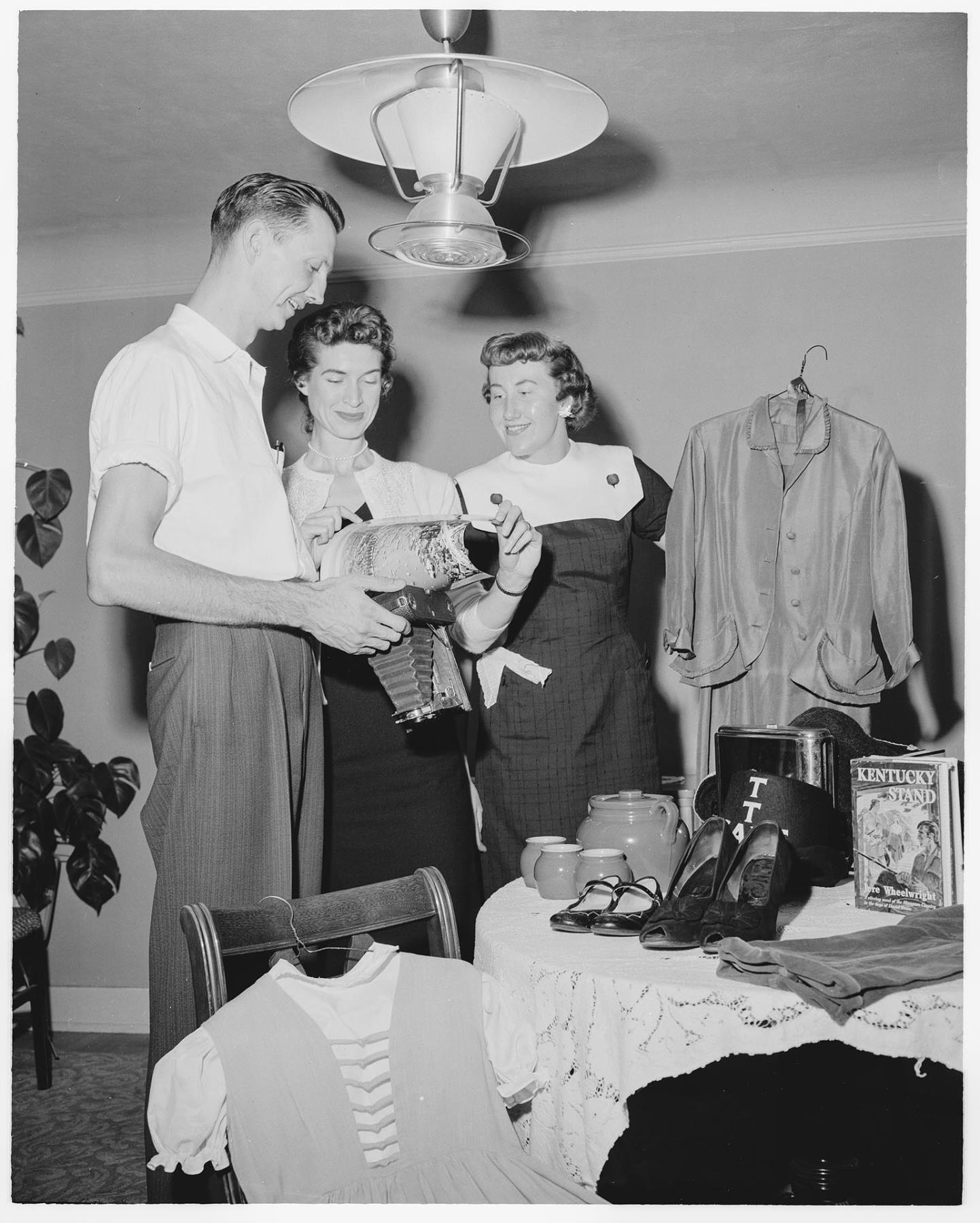 Image of Tip Toppers club members examining sale items, Seattle, August 1958