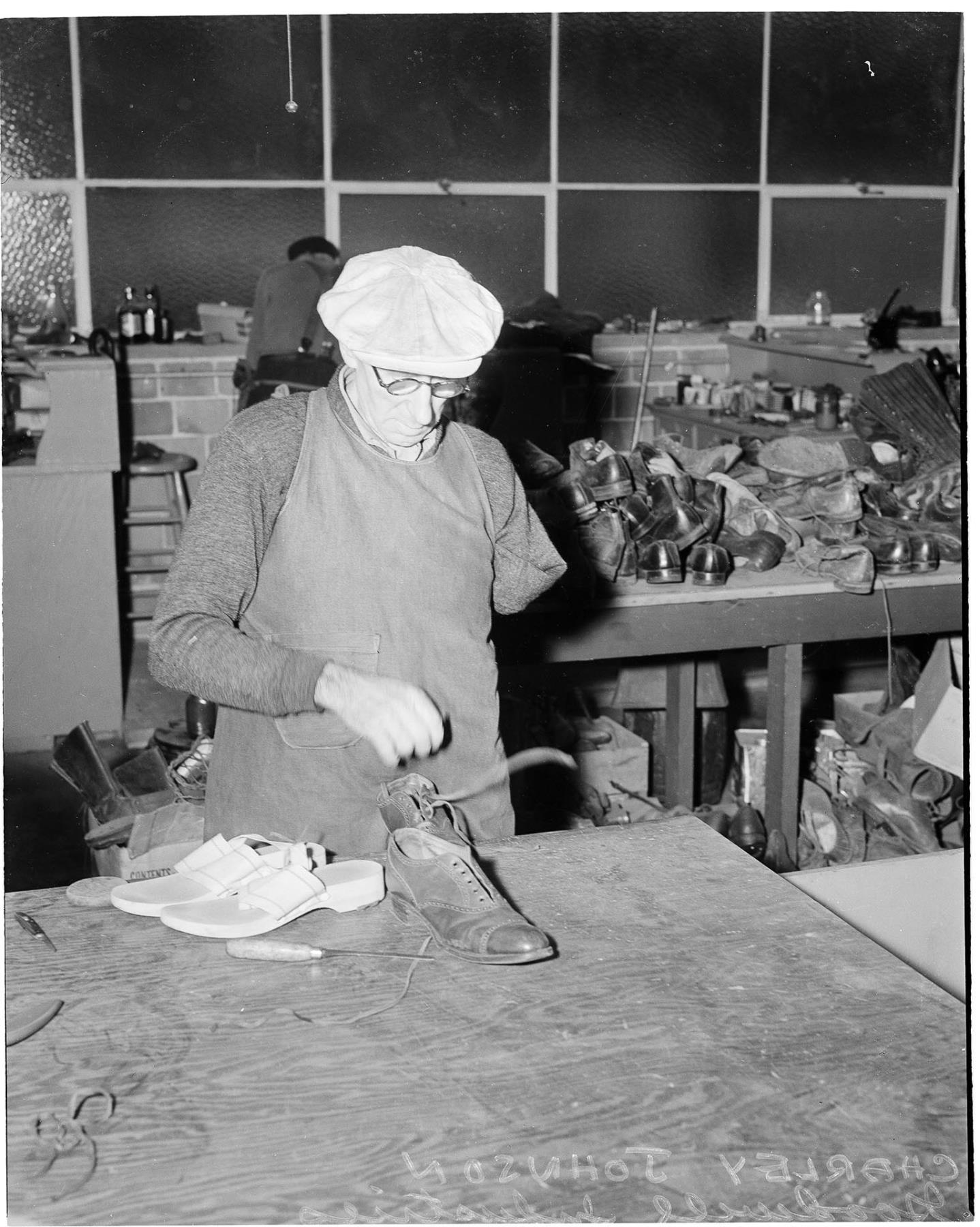 Image of Goodwill employee repairing shoes, Seattle, circa 1960