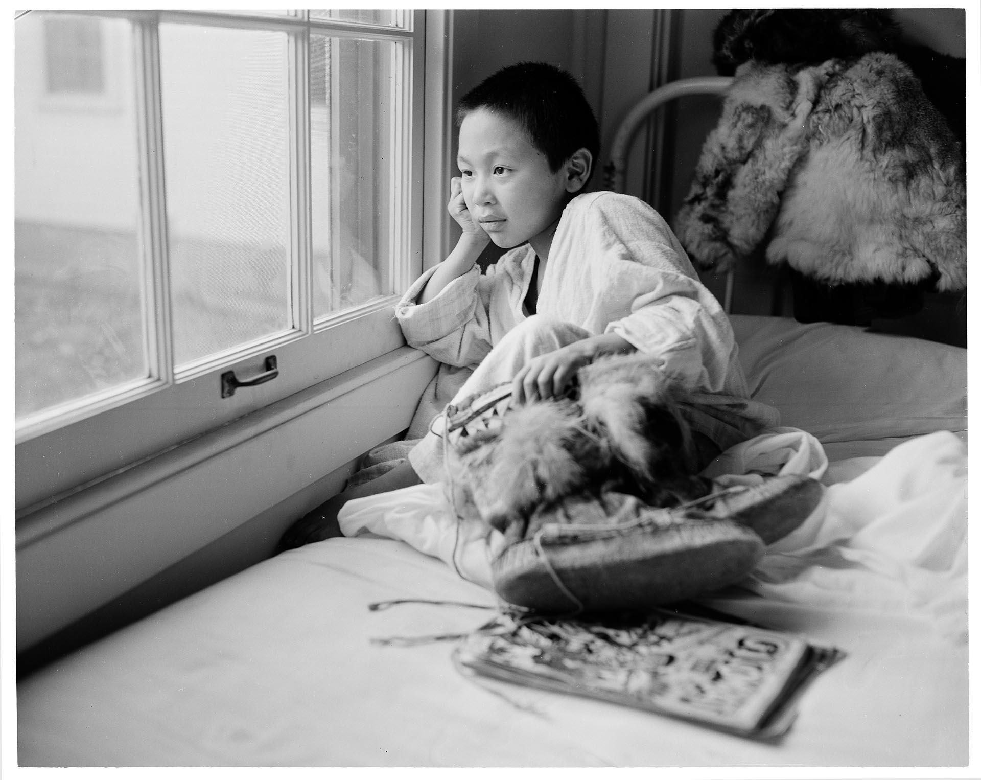 Image of Young patient looking out of window at Firland Sanatorium, Seattle, December 1, 1954