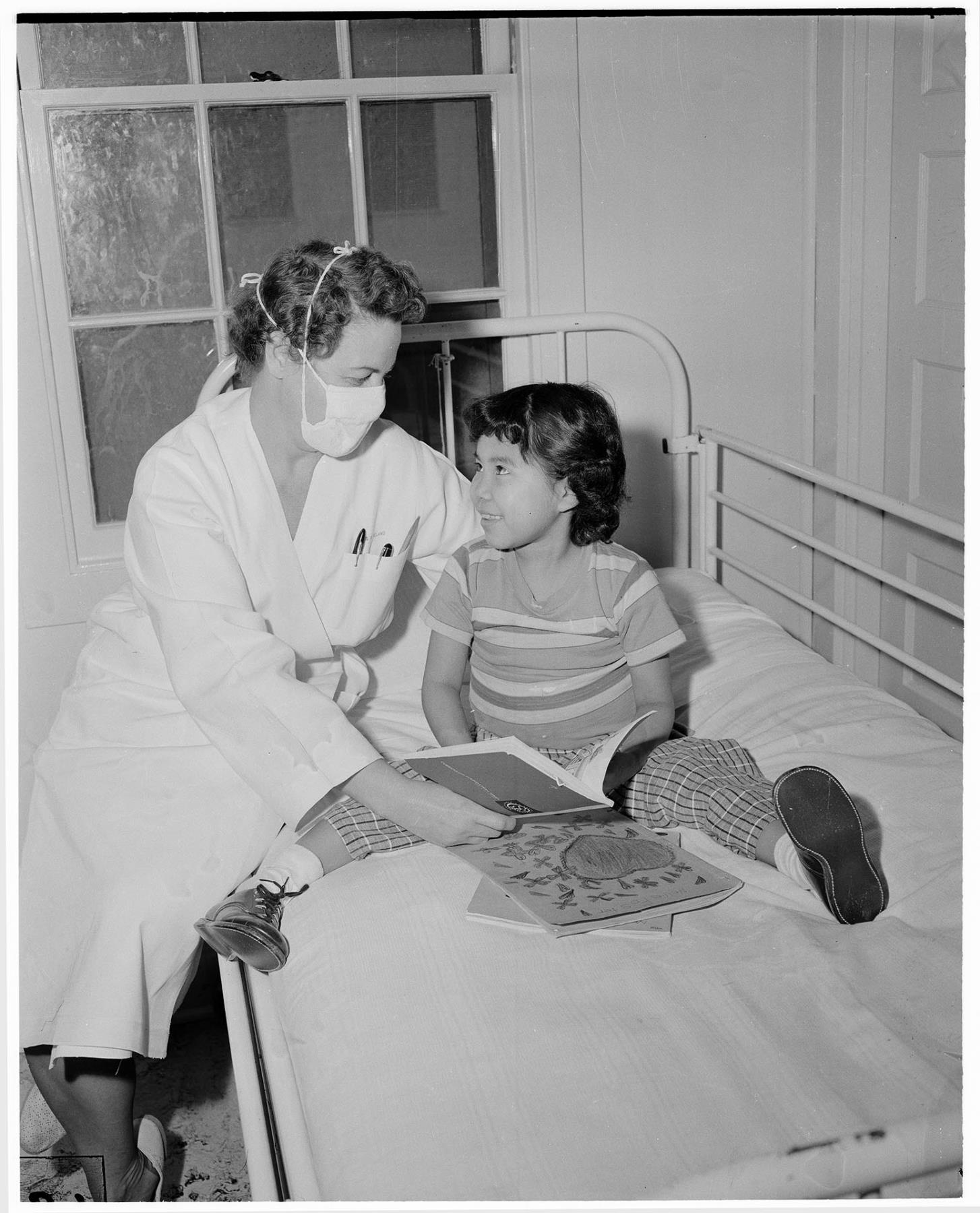 Image of Teacher reading to young girl at Firland Sanitarium, Seattle, November 8, 1955