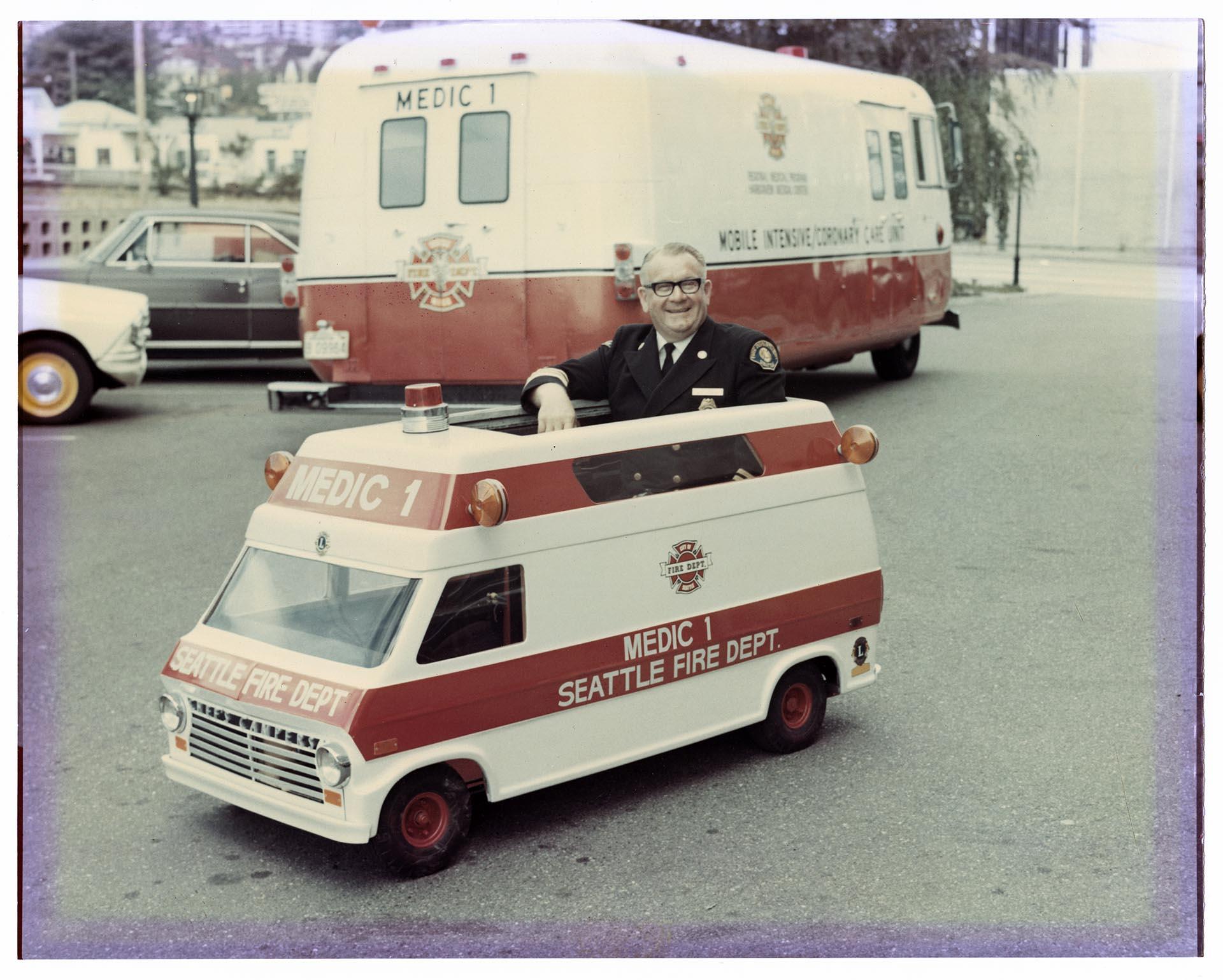 Image of Fire Chief Vickery sitting in Mini Medic 1, Seattle, 1971