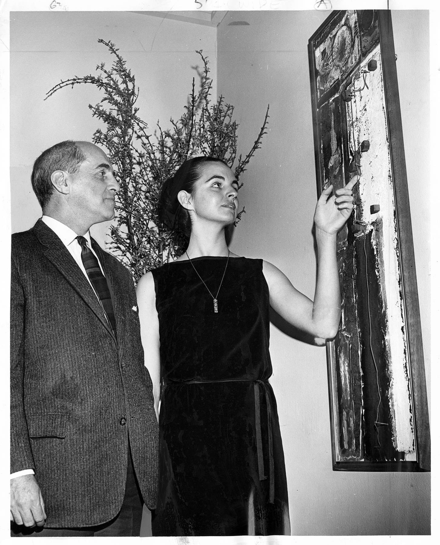Image of Guy Anderson and Mrs. Ray Collins at the Otto Seligman Gallery, March 7, 1965