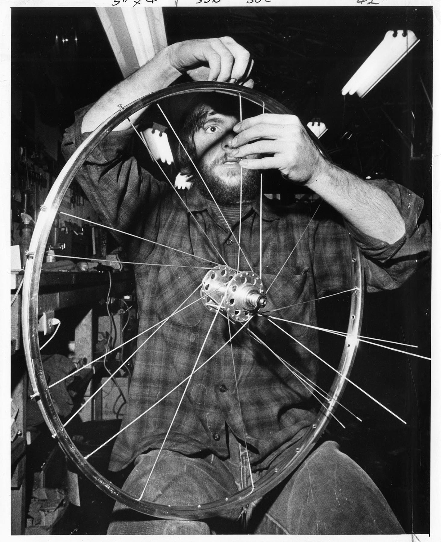 Image of Glenn Erickson working at R&E Cycles, Seattle, May 10, 1974