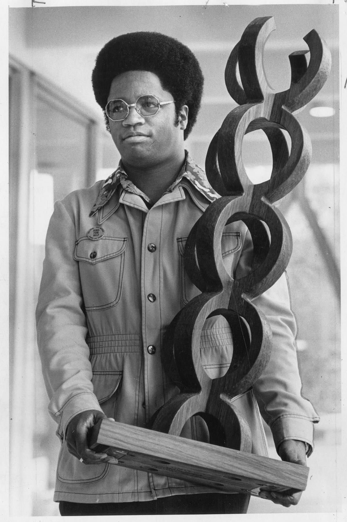 Image of Larry Gossett holding the Odegaard Award, Seattle, April 9, 1975