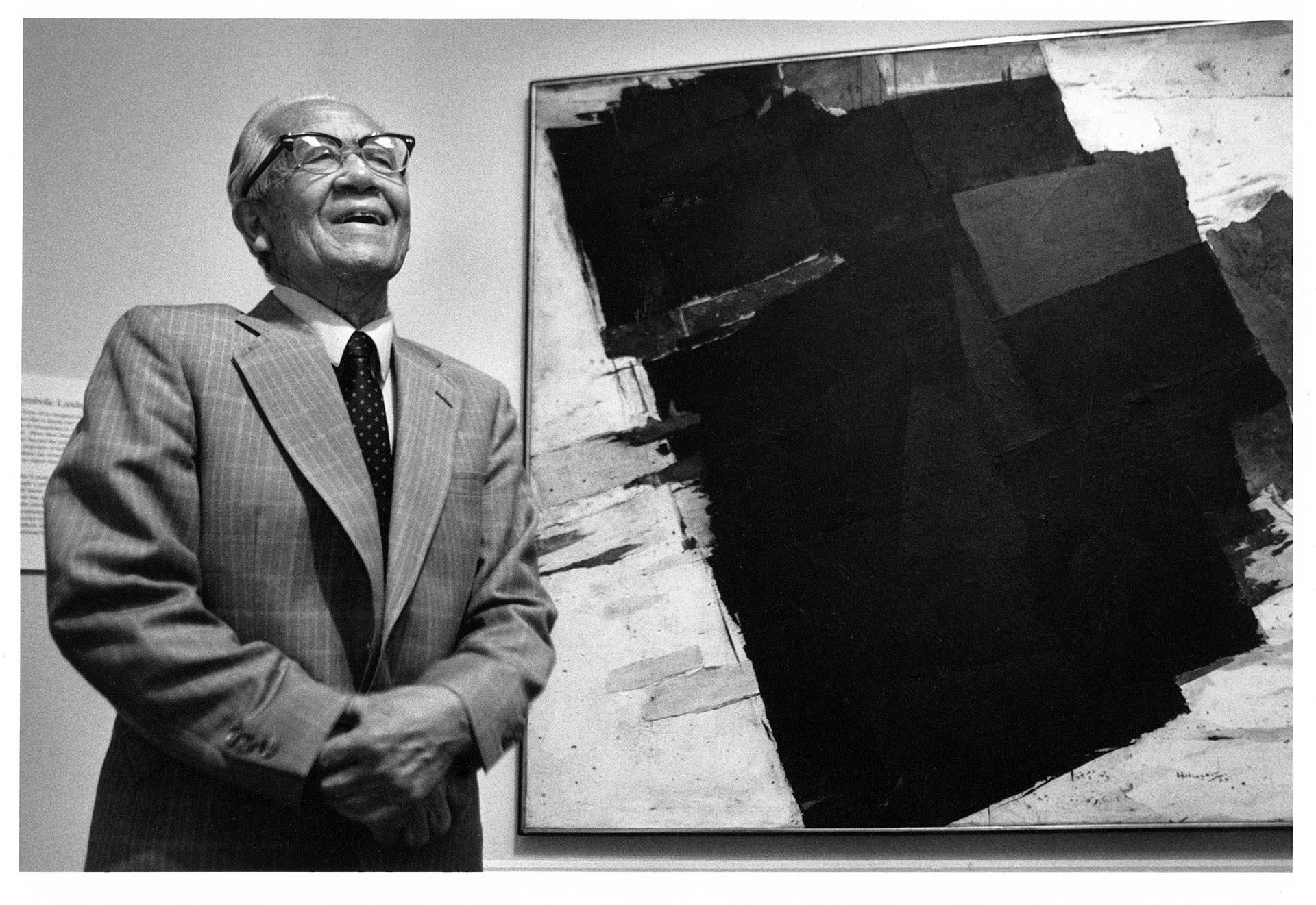 Image of Paul Horiuchi and his painted collage, 