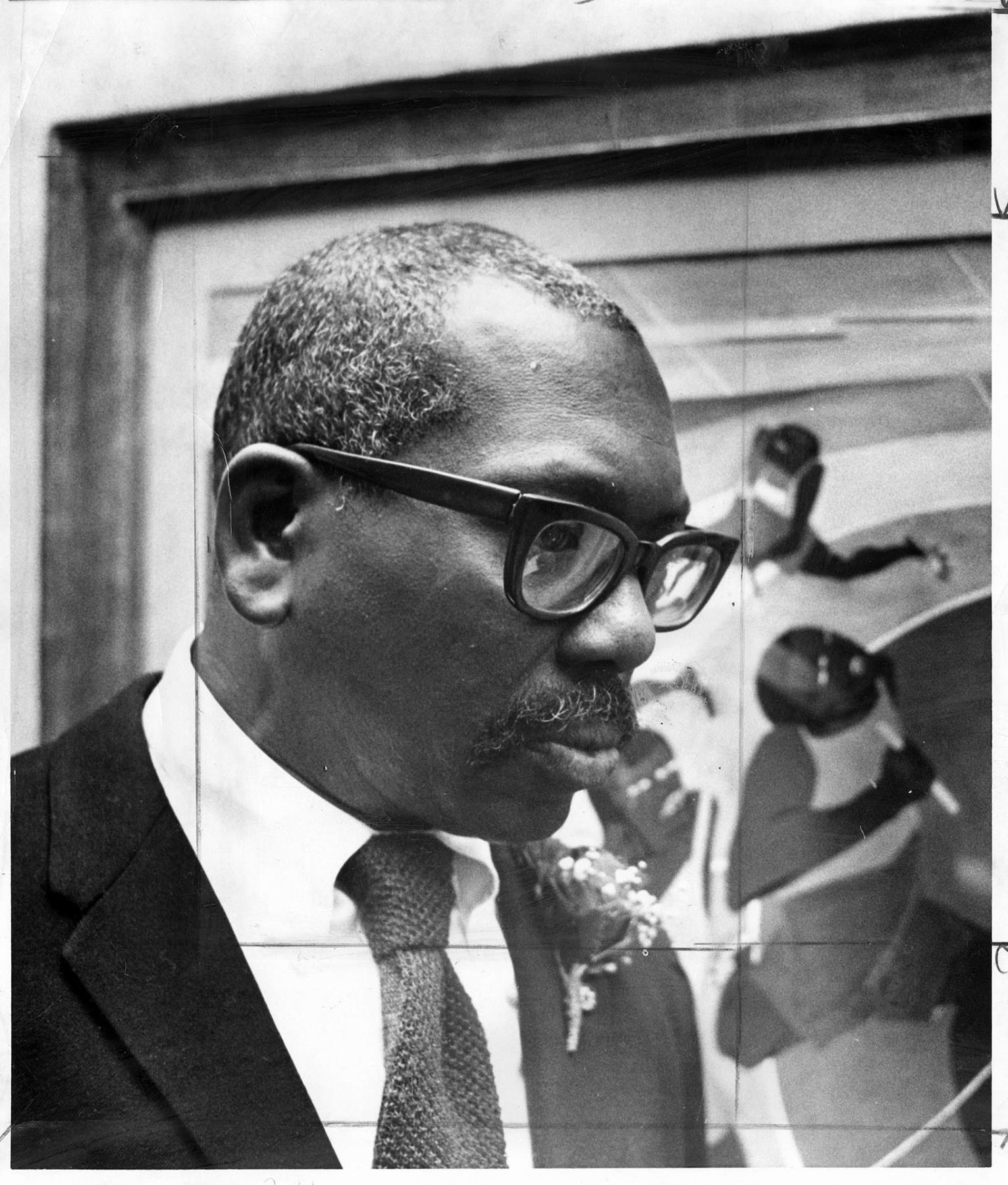 Image of Jacob Lawrence with his painting, Seattle, December 15, 1974