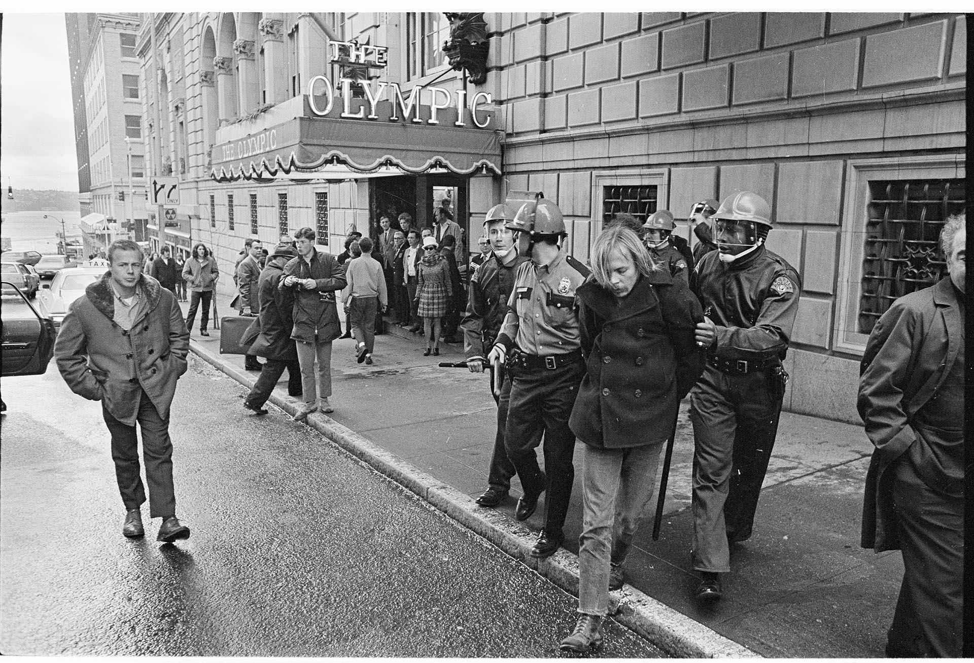 Image of Police arresting protester outside the Olympic Hotel, Seattle, February 17, 1970
