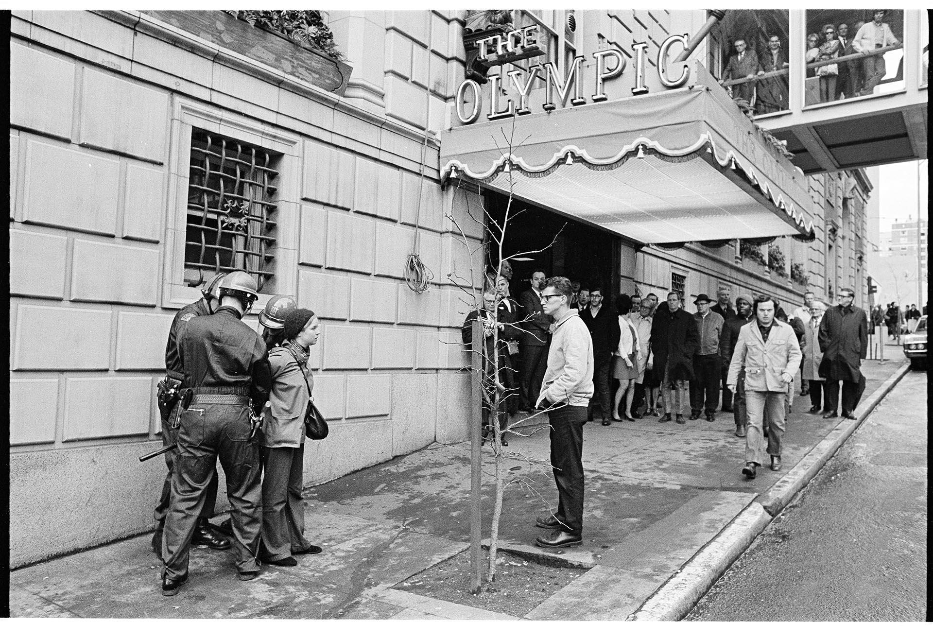 Image of Woman being handcuffed outside the Olympic Hotel, February 17, 1970
