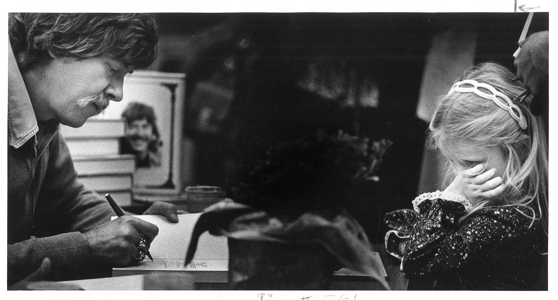 Image of Tom Robbins signing a book for Stacy McNamara, Seattle, October 2, 1980