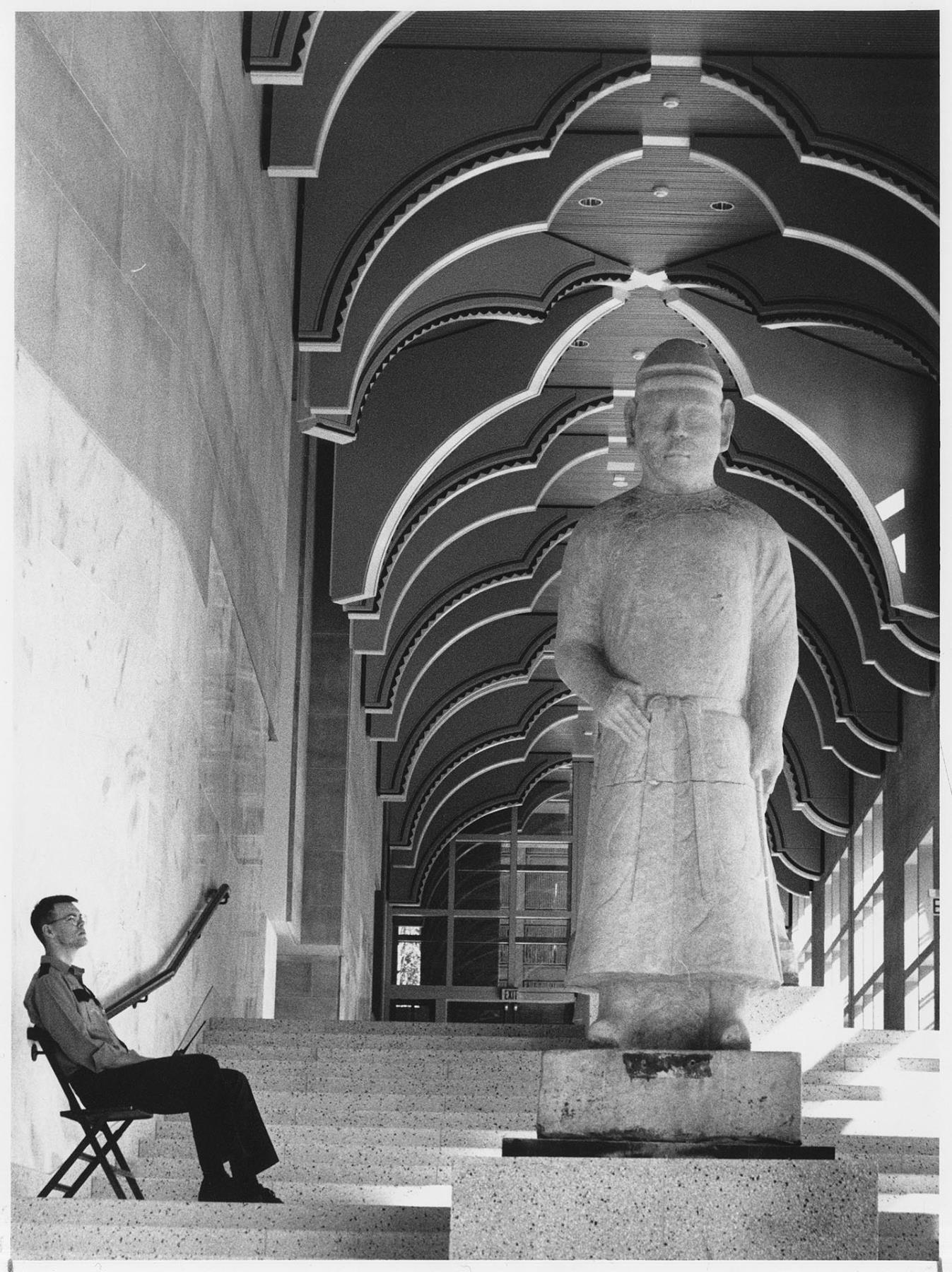 Image of Security guard near Chinese figure at Seattle Art Museum, October 1, 1991