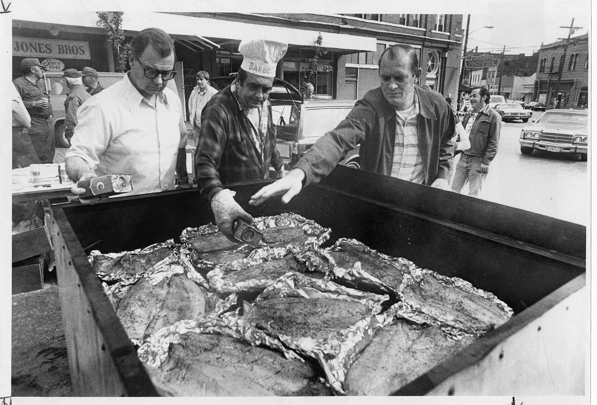 Image of Three men working the salmon grill at Ballard Seafood Fest, September 17, 1977